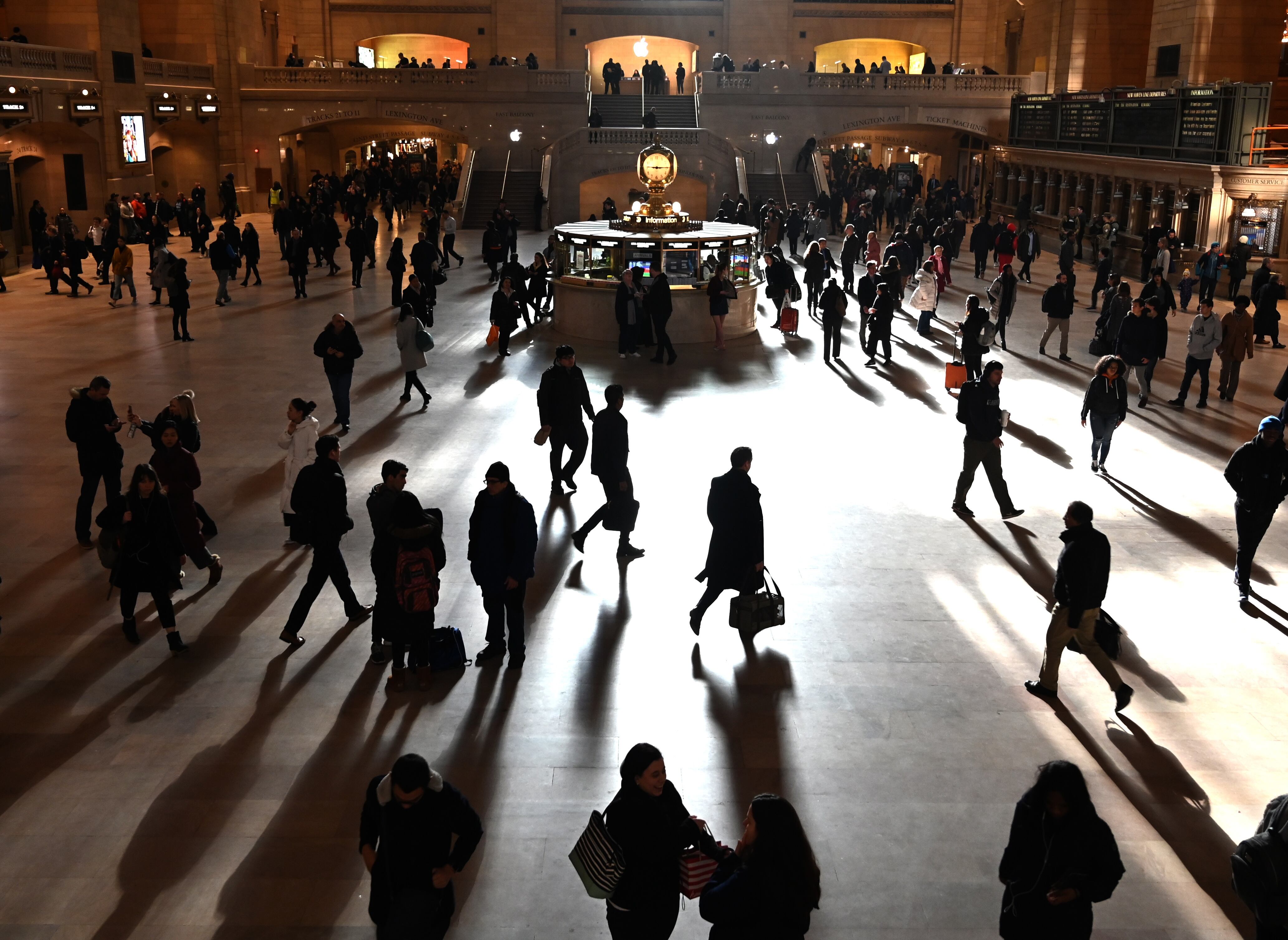 Commuters walk through the morning bright sunlight coming from the 60 feet (18m) high windows in Grand Central Terminal in New York City on March 11, 2019 the first morning after Daylight Savings Time took effect March 10, 2019. (Photo by TIMOTHY A. CLARY / AFP)        (Photo credit should read TIMOTHY A. CLARY/AFP via Getty Images)