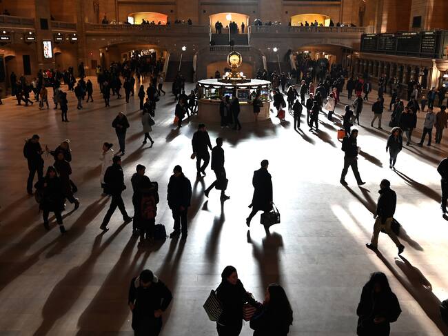 Commuters walk through the morning bright sunlight coming from the 60 feet (18m) high windows in Grand Central Terminal in New York City on March 11, 2019 the first morning after Daylight Savings Time took effect March 10, 2019. (Photo by TIMOTHY A. CLARY / AFP) (Photo credit should read TIMOTHY A. CLARY/AFP via Getty Images)