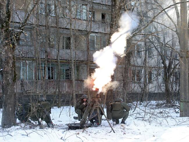 PRYPIAT, UKRAINE - FEBRUARY 4, 2022 - Soldiers shoot a mortar during tactical drills for Ukrainian Interior Ministry units to practice interoperability while defending a city, urban combat tactics and response to the aftermath of the hostilities in a city, Prypiat, the Chornobyl Exclusion Zone, Kyiv Region, northern Ukraine. (Photo credit should read Volodymyr Tarasov/ Ukrinform/Future Publishing via Getty Images)