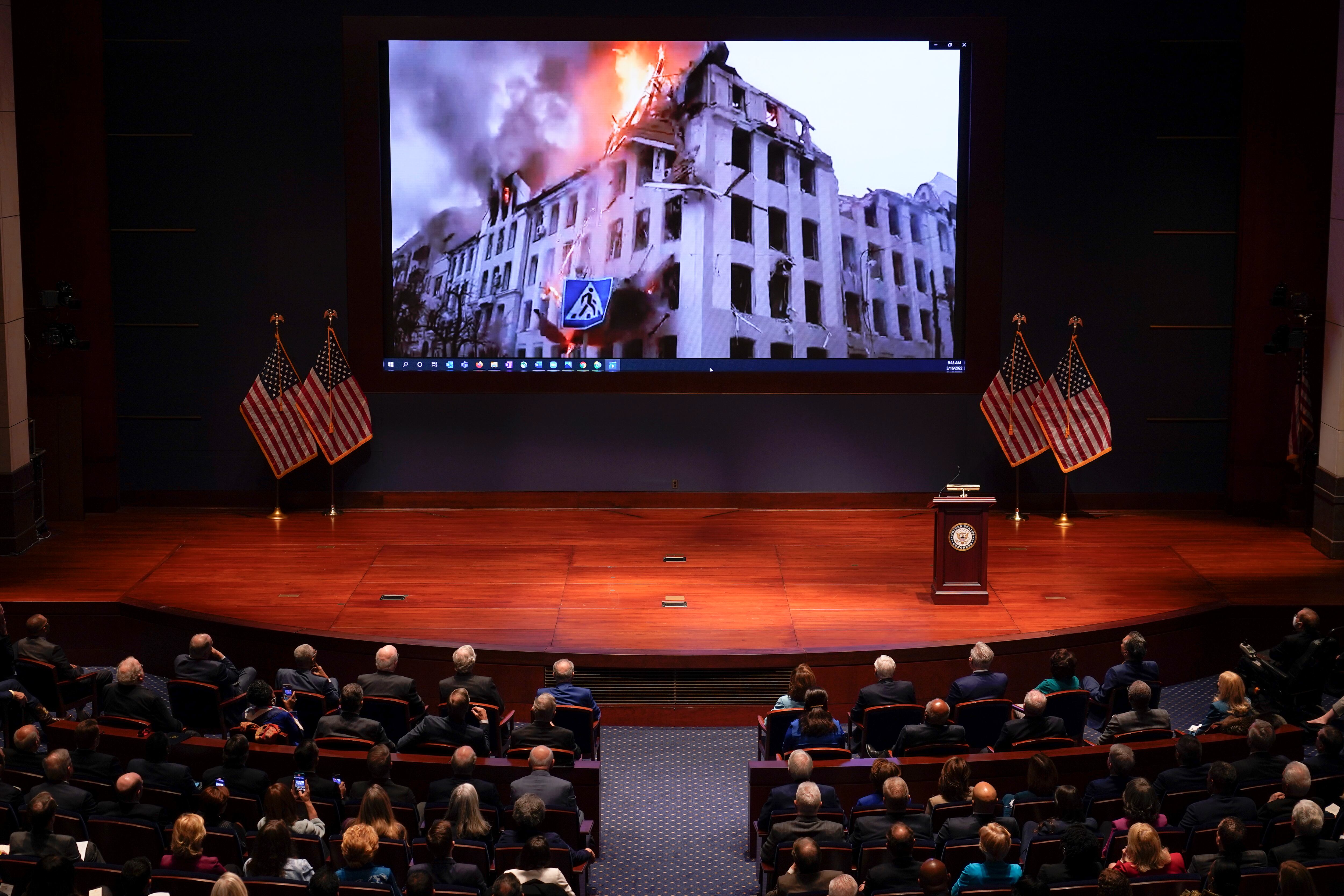 WASHINGTON, DC - MARCH 16: Footage of the war in Ukraine is displayed as Ukrainian President Volodymyr Zelenskyy speaks to the U.S. Congress by video to plead for support as his country is besieged by Russian forces at the U.S. Capitol on March 16, 2022 in Washington, DC. Zelenskyy addressed Congress as Ukraine continues to defend itself from an ongoing Russian invasion. (Photo by J. Scott Applewhite-Pool/Getty Images)