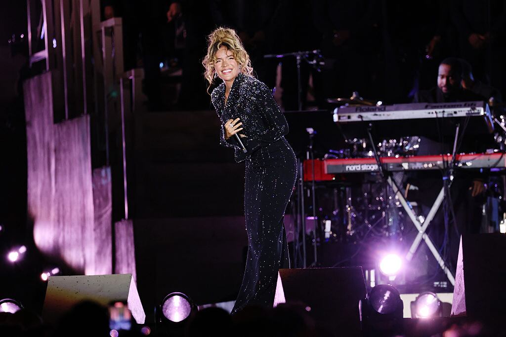 Karol G performs on the stage during the 'Grace For The World'. (Photo by Ernesto Ruscio/WireImage)