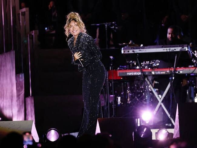 Karol G performs on the stage during the 'Grace For The World'. (Photo by Ernesto Ruscio/WireImage)