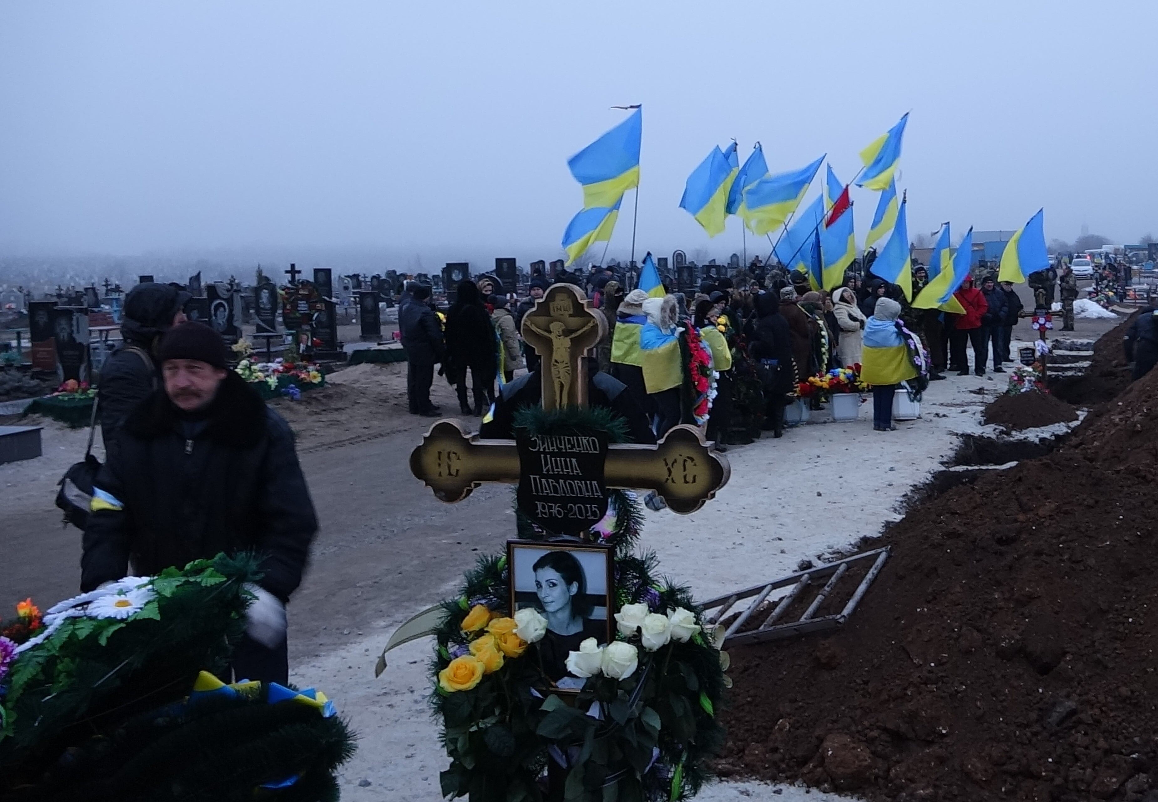 MARIUPOL, UKRAINE - JANUARY 27: Mourners stand by the death bodies of Nikolay and Lyubov Bobilev, their daughter Marina Kashina, and their 3-years old grandson Vyacheslav during their funeral ceremony, in Ukraine's Eastern City Mariupol on January 27, 2015. The four victims killed by the separatists' artillery attacks on 24th of January. (Photo by Nikolay Ryabcenko/Anadolu Agency/Getty Images)