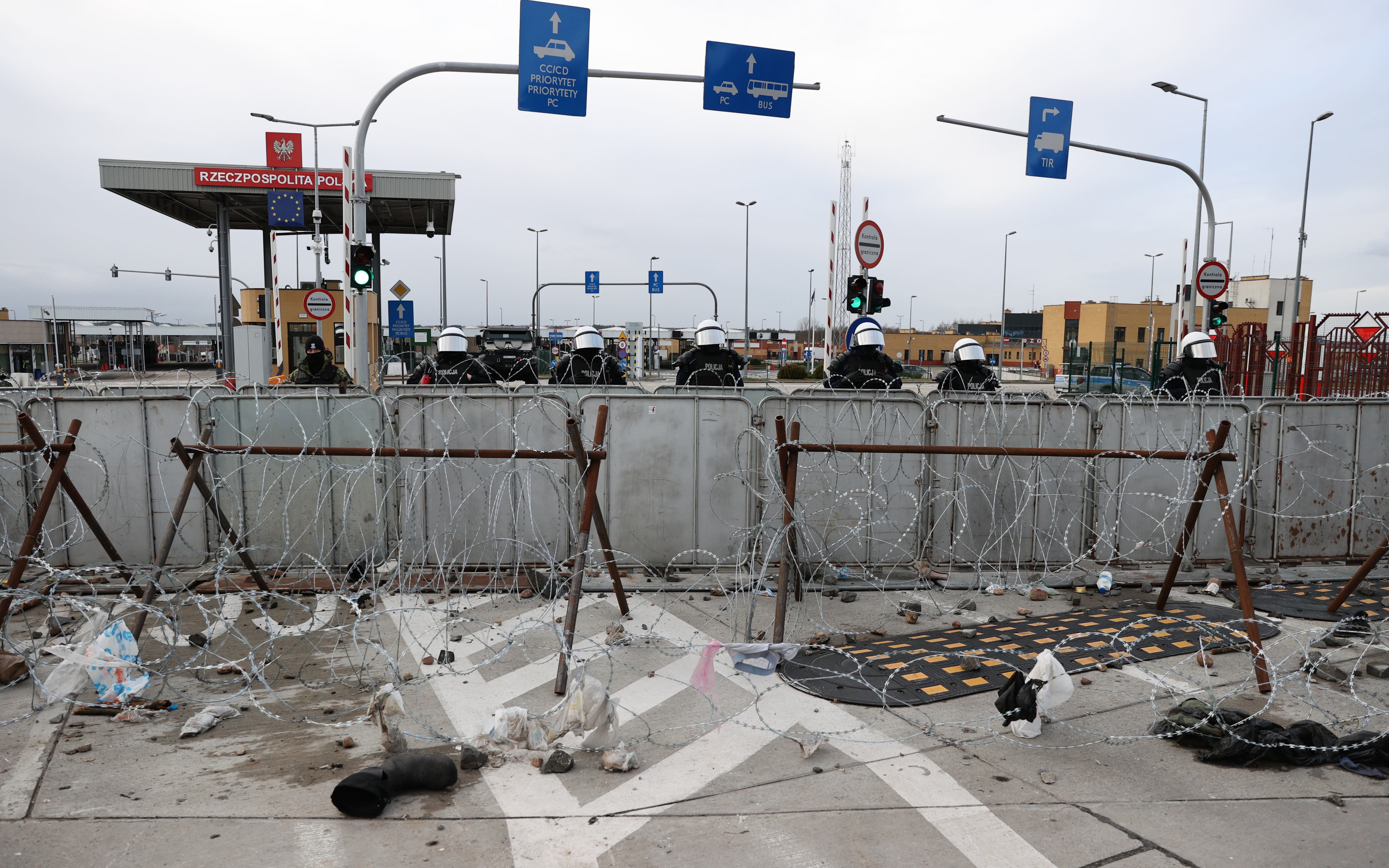 GRODNO REGION, BELARUS - NOVEMBER 22, 2021: A Polish police force are seen behind a barbed wire fence at Kuznica Bialostocka-Bruzgi border crossing on the Belarusian-Polish border. The migrant crisis on the border of Belarus with Poland, Lithuania, and Latvia escalated on November 8. This year, Polish border guards have prevented more than 35,000 attempts to illegally cross the Polish-Belarusian border, which is 400 times more than last year. Sergei Bobylev/TASS (Photo by Sergei Bobylev\TASS via Getty Images)