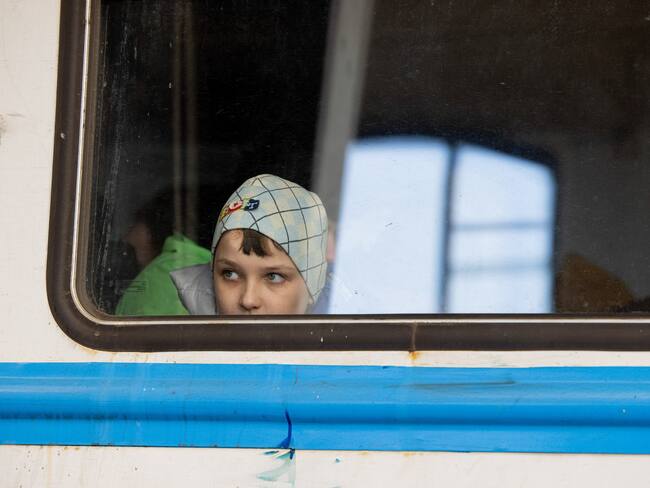 LVIV, UKRAINE - 2022/03/11: A young child in the train carriage is seen through the window at the Lviv train station. Lviv, the largest city in western Ukraine, has now become a transit hub for women and children fleeing to Europe, while men return and travel to eastern Ukraine to defend the country. (Photo by Hesther Ng/SOPA Images/LightRocket via Getty Images)