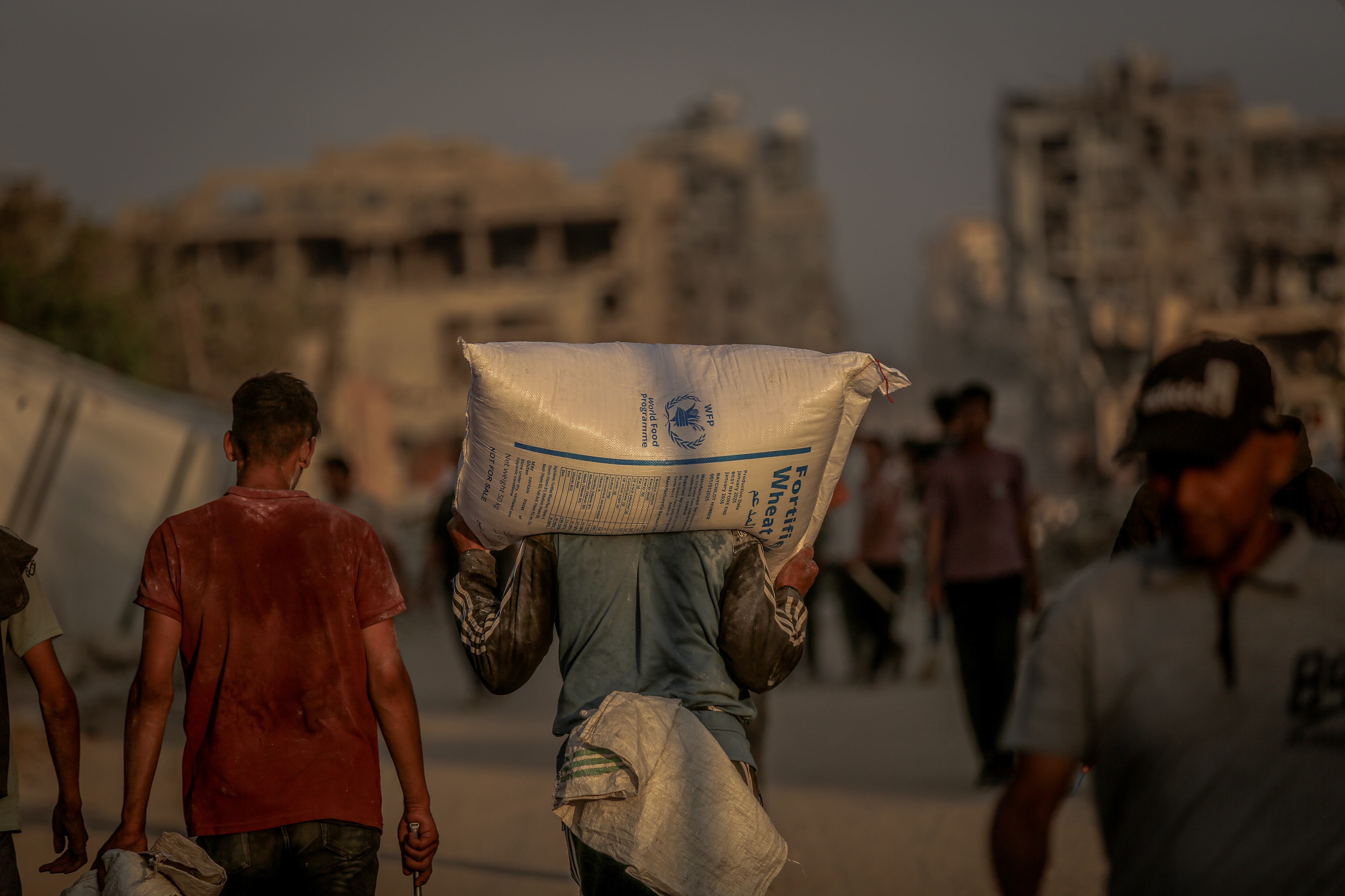 GAZA CITY, GAZA - JUNE 17:  Palestinians flock to the aid center set up by the US and Israeli-led Gaza Humanitarian Relief Foundation on the Coastal Road in the Sudaniya area to receive food package in northern Gaza City, Gaza on June 17, 2025. (Photo by Saeed M. M. T. Jaras/Anadolu via Getty Images)