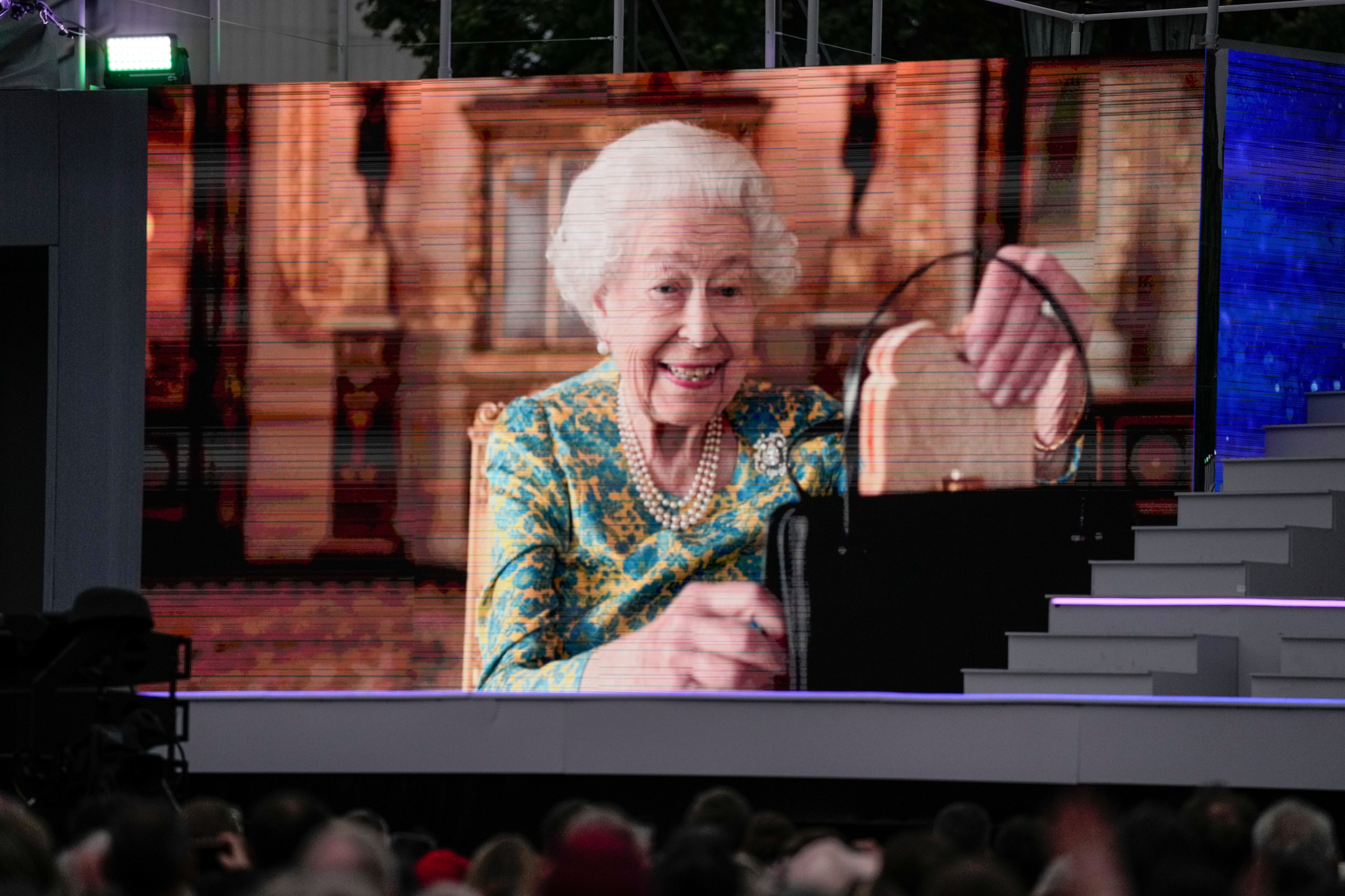 LONDON, ENGLAND - JUNE 04: Queen Elizabeth II is seen onscreen during the Platinum Party At The Palace at Buckingham Palace on June 4, 2022 in London, England. The Platinum Jubilee of Elizabeth II is being celebrated from June 2 to June 5, 2022, in the UK and Commonwealth to mark the 70th anniversary of the accession of Queen Elizabeth II on 6 February 1952.  (Photo by Alastair Grant - WPA Pool/Getty Images)