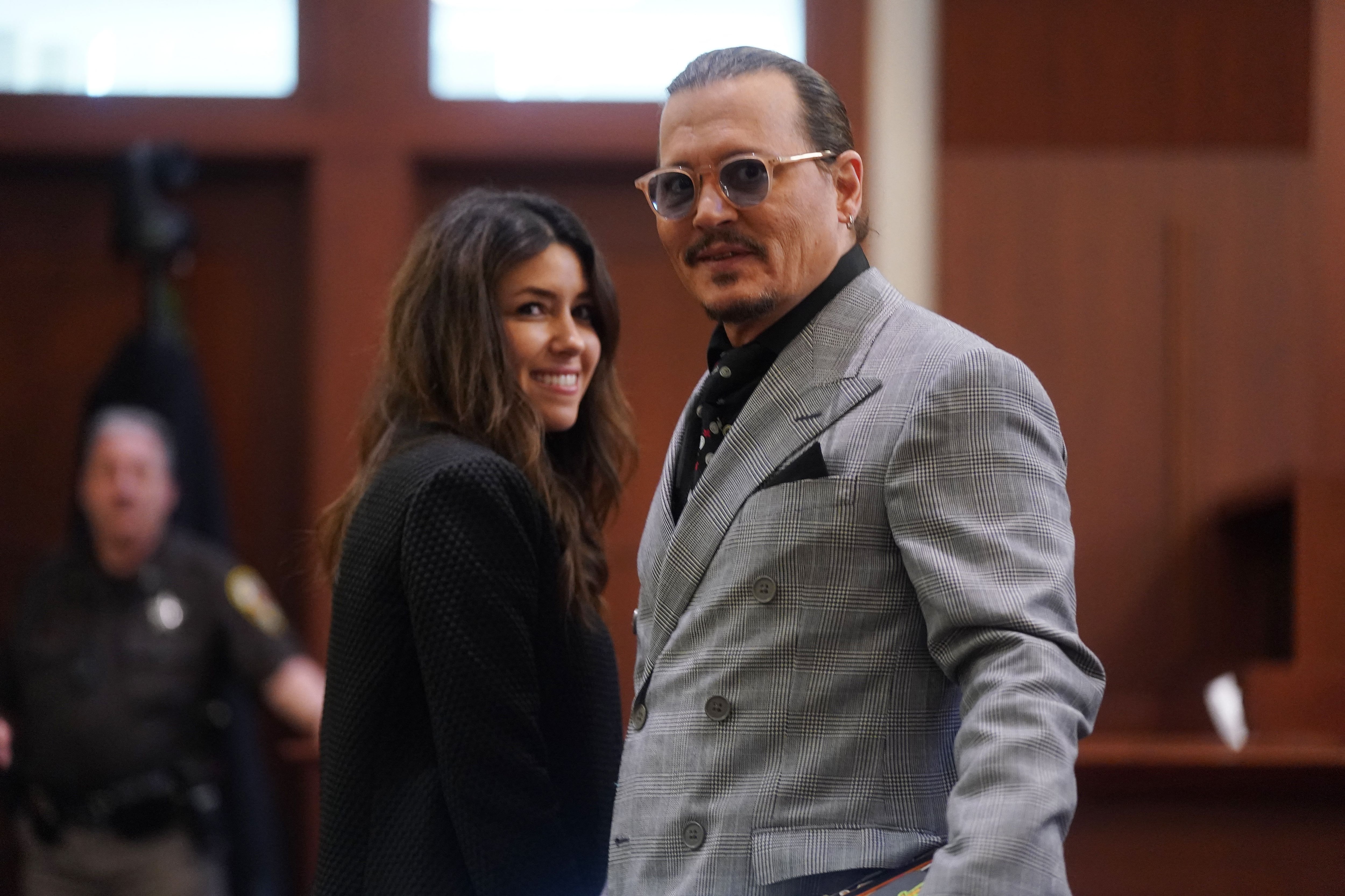 US actor Johnny Depp (R) and his attorney Camille Vasquez (L) during a break in the 50 million US dollar Depp vs Heard defamation trial at the Fairfax County Circuit Court in Fairfax, Virginia, on May 19, 2022. - Actor Johnny Depp is suing ex-wife Amber Heard for libel after she wrote an op-ed piece in The Washington Post in 2018 referring to herself as a public figure representing domestic abuse. (Photo by Shawn THEW / POOL / AFP) (Photo by SHAWN THEW/POOL/AFP via Getty Images)
