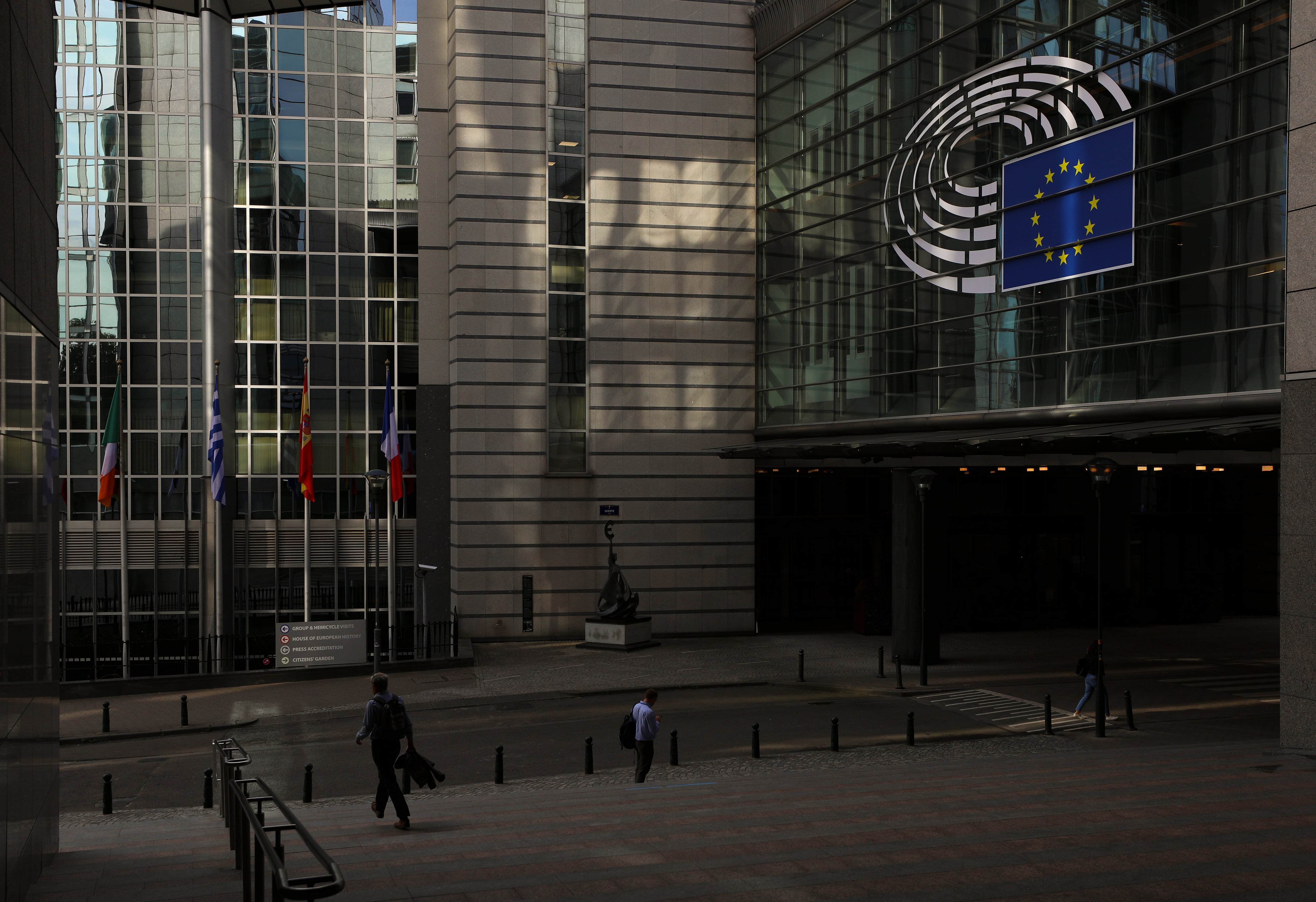 People go to work early in the morning past the European Parliament in Brussels. Belgium, Wednesday, July 6th, 2022. (Photo by Danil Shamkin/NurPhoto via Getty Images)