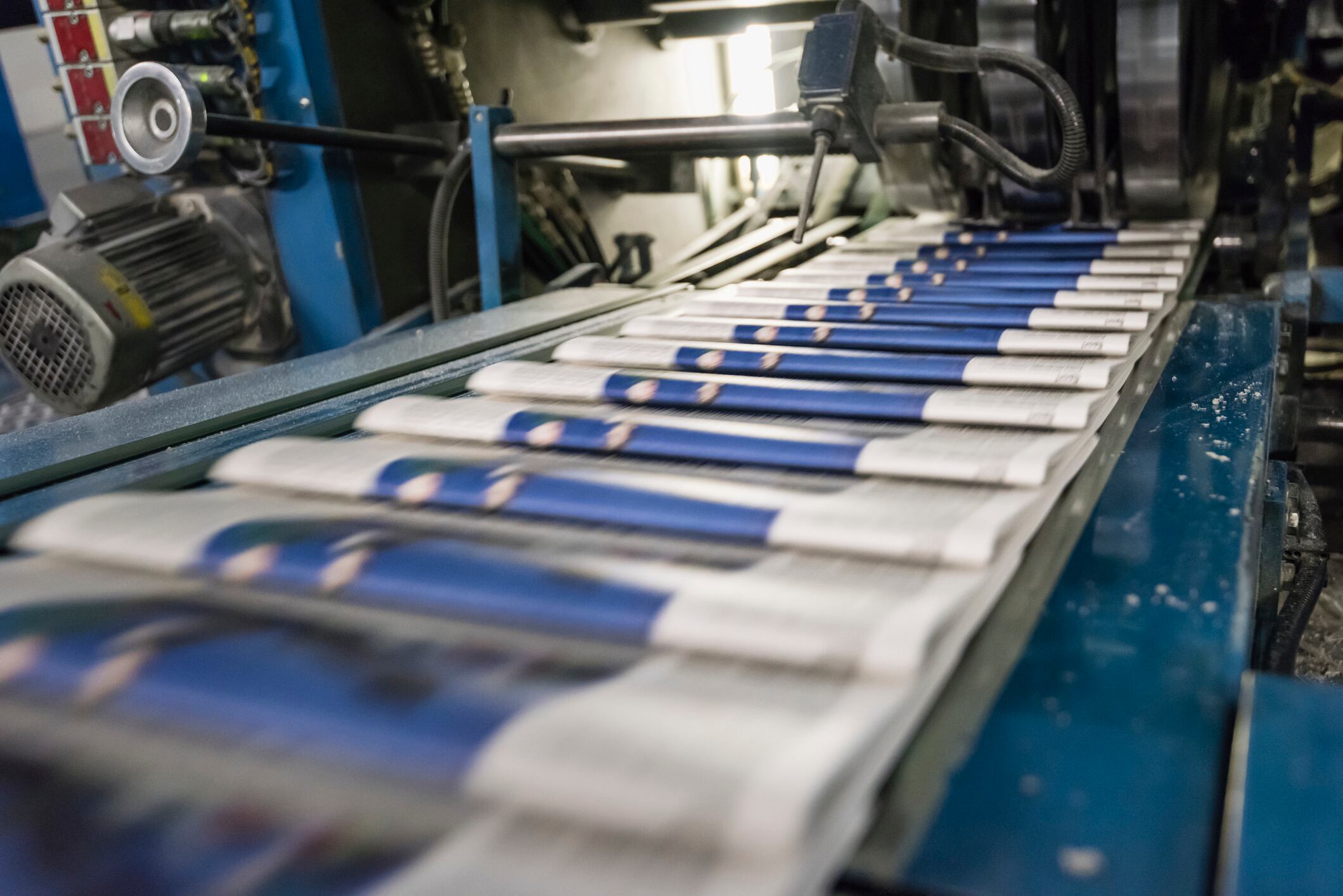 Freshly printed 'Zurich Tagesanzeiger' newspapers are coming out of the rotary press at the printing facility of Tamedia in Zurich, the largest newspaper printing plant in Switzerland. Every week, about ten million daily and weekly newspapers as well as advertising material are produced, packaged and shipped at the plant.