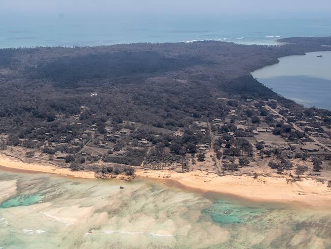 NOMUKA, TONGA - JANUARY 17: In this handout photo provided by the New Zealand Defense Force, an aerial view from a P-3K2 Orion surveillance flight of heavy ash fall on January 17, 2022 Nomuka, Tonga. A 5 Squadron crew work on board whilst flying overhead to provide vital information to send back to MFAT and various other government agencies. Tonga was struck by a tsunami caused by an undersea volcano erupting in the Pacific Ocean on January 15th. (Photo by New Zealand Defense Force via Getty Images)
