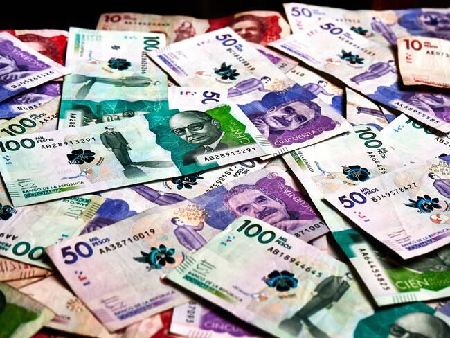 Table full of colombian banknotes of various denominations that serve to stop the salaries of workers, make commercial transactions and sell and buy any type of article