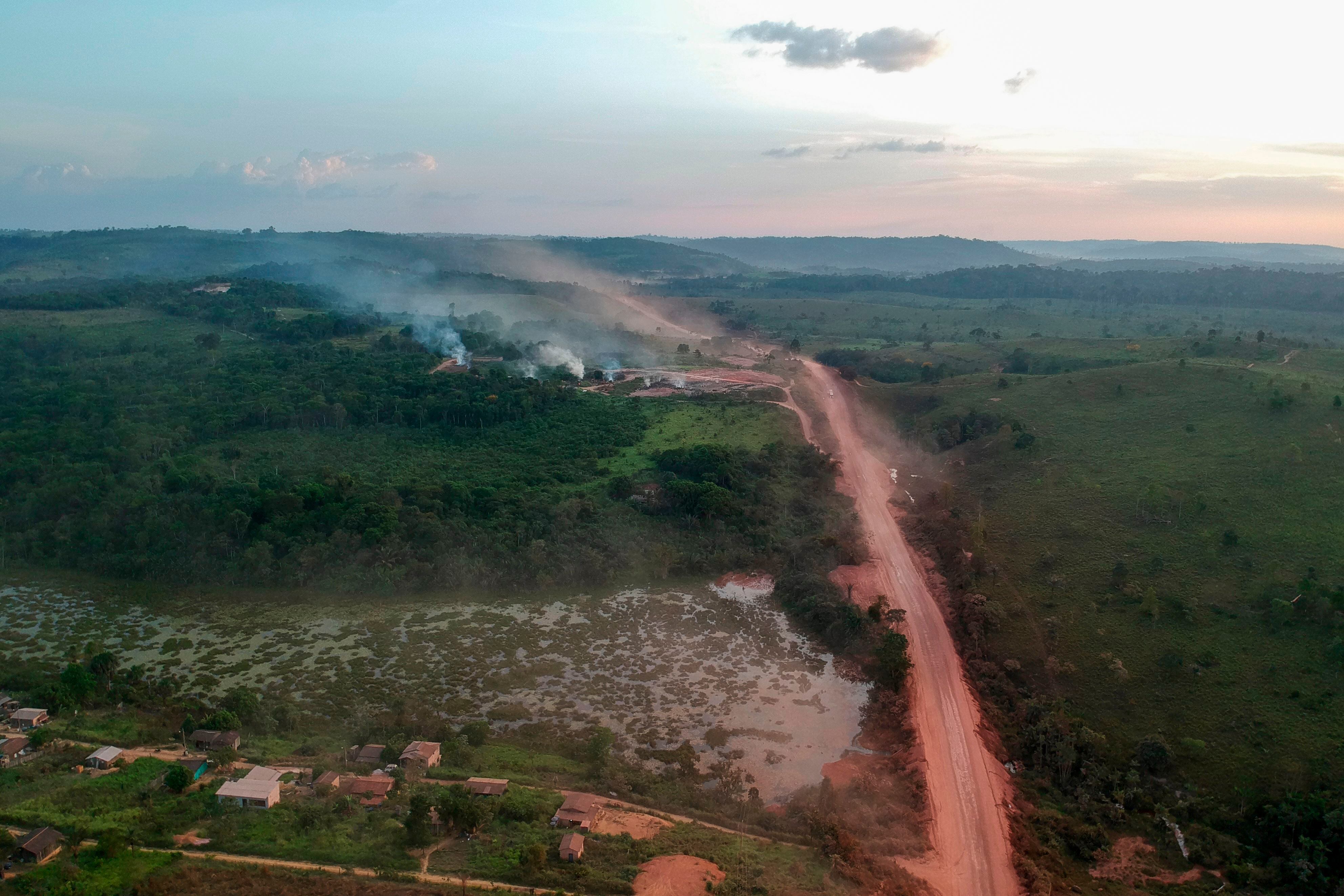 In this aerial view the red dust of the BR230 highway, known as "Transamazonica", mixes with fires at sunset in the agriculture town of Ruropolis, Para state, northen Brazil, on September 6, 2019. - Presidents and ministers from seven Amazon countries met in Colombia on Friday to agree on  measures to protect the world's biggest rainforest, under threat from wildfires and rampant deforestation. The summit took place in the wake of an international outcry over months of raging fires that have devastated swaths of the Amazon in Brazil and Bolivia. (Photo by Johannes MYBURGH / AFP)        (Photo credit should read JOHANNES MYBURGH/AFP via Getty Images)