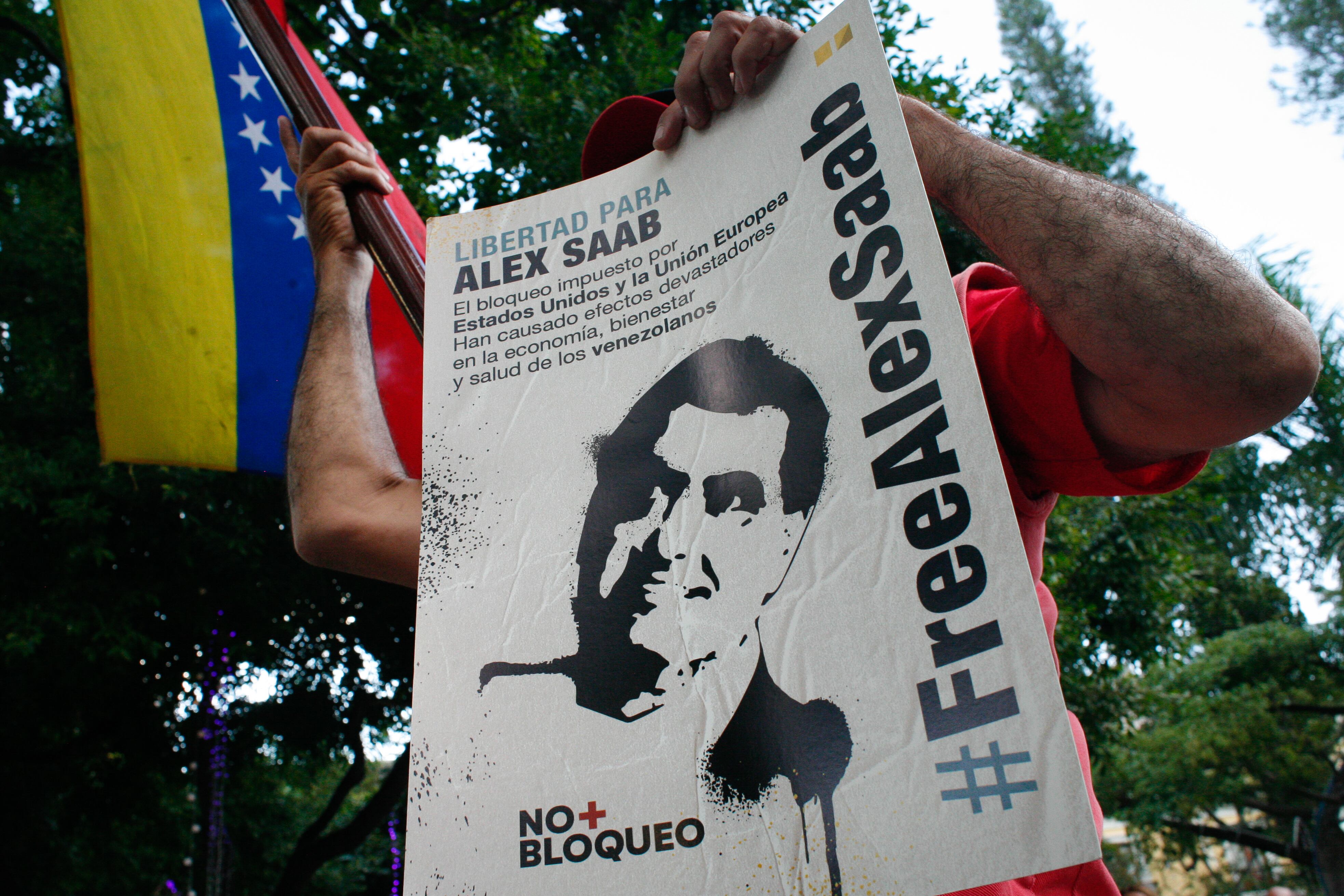 A man holds a sign calling for the release of Alex Saab at a rally in solidarity with the Colombian businessman following his extradition to the United States from Cape Verde amid the Coronavirus pandemic in Caracas, Venezuela October 17, 2021. (Photo by Javier Campos/NurPhoto via Getty Images)