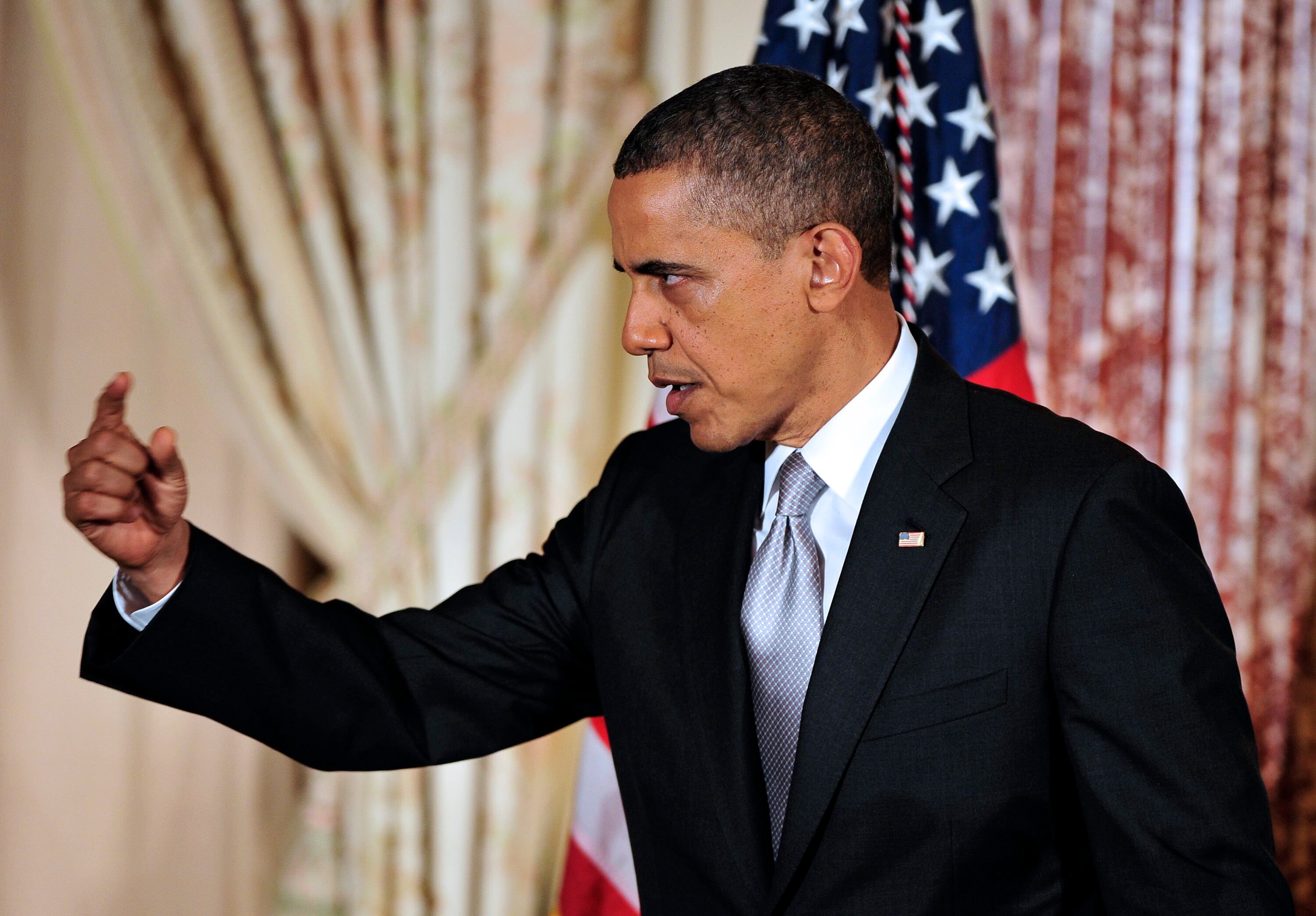WASHINGTON, DC - DECEMBER 12:  U.S. President Barack Obama gestures after delivering remarks at the Diplomatic Corps Holiday Reception on December 19, 2012 in Washington, D.C. President Obama announced that he is making an administration-wide effort to solve gun violence and has tapped Vice President Joseph Biden to lead the effort in the wake of the Sandy Hook Elementary School shooting in Newtown, Connecticut. (Photo by Ron Sachs-Pool/Getty Images)