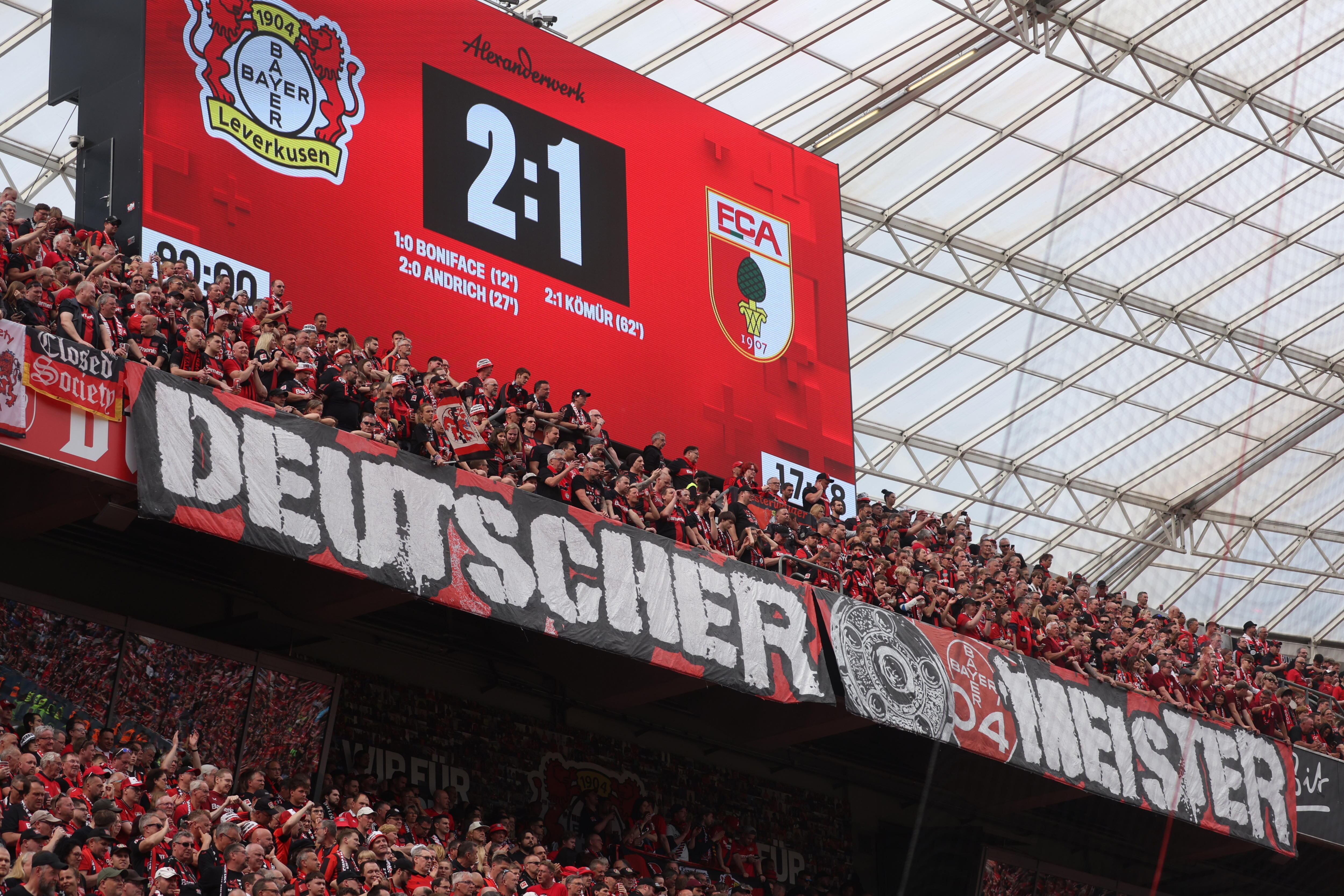 Leverkusen (Germany), 18/05/2024.- Supporters of Leverkusen show a banner reading 'German Champion' after the German Bundesliga soccer match of Bayer 04 Leverkusen against FC Augsburg, in Leverkusen, Germany, 18 May 2024. (Alemania) EFE/EPA/CHRISTOPHER NEUNDORF CONDITIONS - ATTENTION: The DFL regulations prohibit any use of photographs as image sequences and/or quasi-video.
