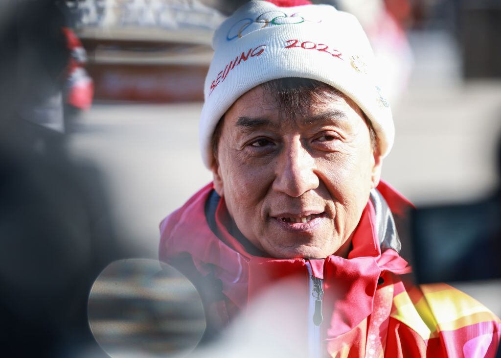 BEIJING, CHINA - FEBRUARY 03: Actor Jackie Chan carries the torch during the Beijing 2022 Winter Olympics Torch Relay at the Badaling Great Wall on February 3, 2022 in Beijing, China. (Photo by Zhang Xin/CHINASPORTS/VCGe)