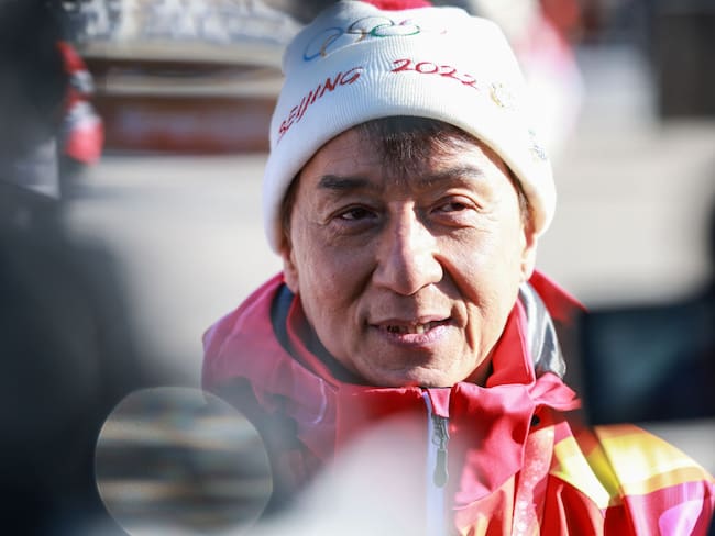 BEIJING, CHINA - FEBRUARY 03: Actor Jackie Chan carries the torch during the Beijing 2022 Winter Olympics Torch Relay at the Badaling Great Wall on February 3, 2022 in Beijing, China. (Photo by Zhang Xin/CHINASPORTS/VCGe)