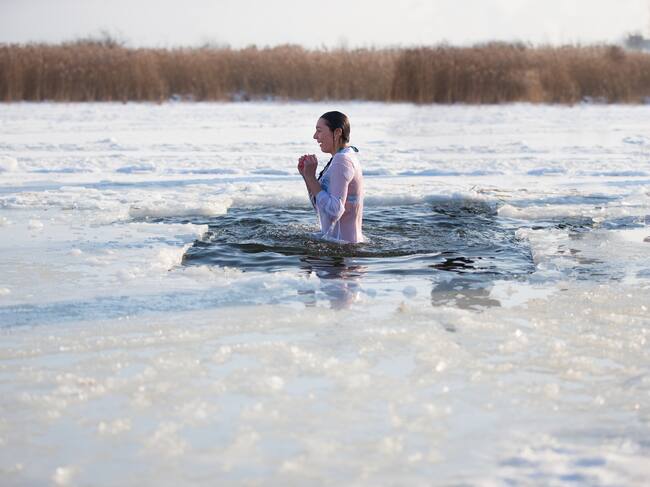 Epiphany.Bathing in the ice hole at the baptism of the Lord. A woman is dipped in cold water
