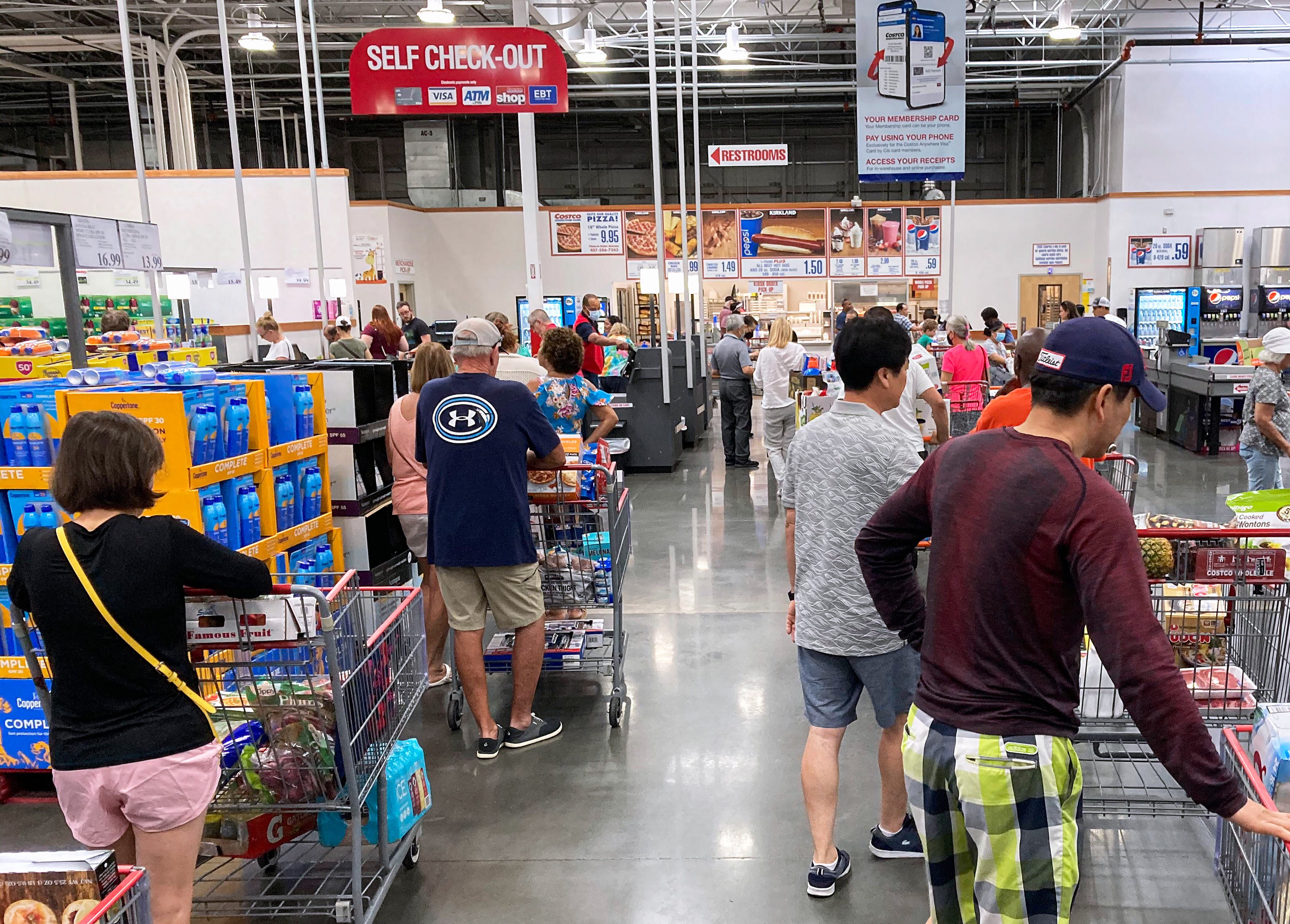 ORLANDO, FLORIDA, UNITED STATES - 2022/05/31: Shoppers wait in a check-out line at a Costco wholesale store in Orlando. Costco reported a double-digit rise in sales during the third quarter and record numbers of new members as consumers look for ways to fight rising food prices caused by inflation. (Photo by Paul Hennessy/SOPA Images/LightRocket via Getty Images)