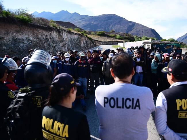 Oficiales de policía negocian con campesinos y líderes mientras bloquean una carretera a la entrada de Abancay, Perú, el 19 de diciembre de 2022. -