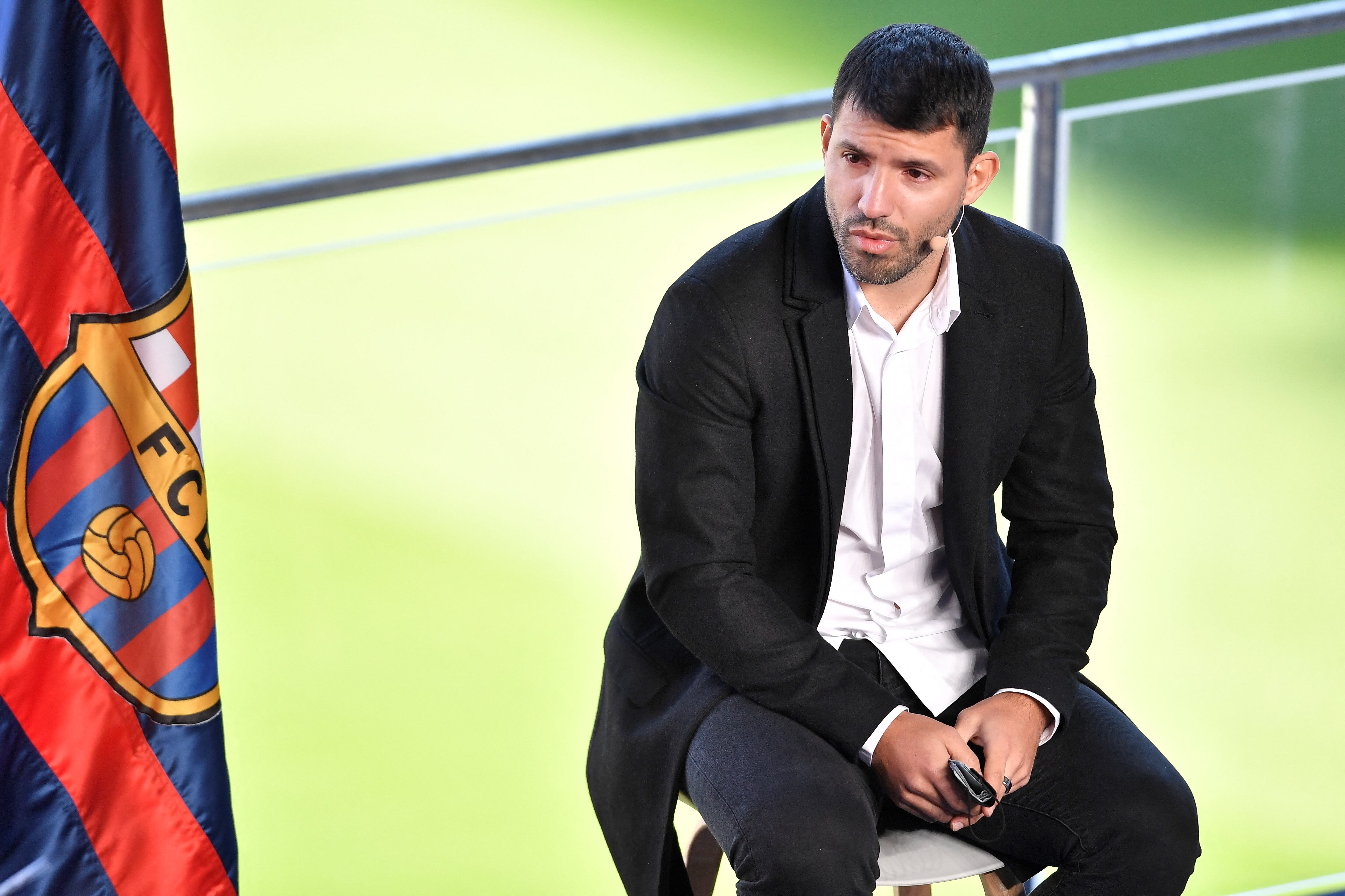 Barcelona's Argentinian forward Kun Aguero reacts as he addresses a press conference to announce his retirement from football, at the Camp Nou stadium in Barcelona, on December 15, 2021. (Photo by Pau BARRENA / AFP)