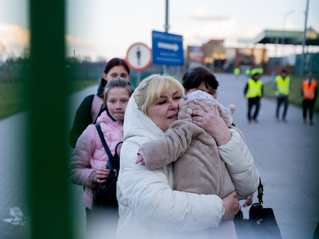 11 April 2022, Poland, Przemysl: Grandmother Larissa holds her six-month-old grandson Artyom in her arms at the Medyka border crossing just over the Ukrainian border on the Polish side as she receives her family who have fled from Melitopol on the Azov. She herself has already been working for 10 months in Swinoujscie, Poland, as a kitchen helper. Photo: Christoph Soeder/dpa (Photo by Christoph Soeder/picture alliance via Getty Images)
