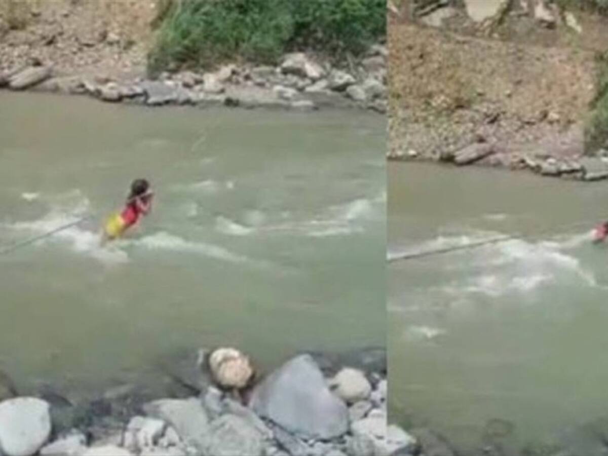 Niña indígena de Risaralda intentando cruzar un río con una cuerda causa indignación