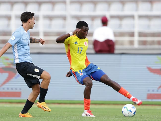 AMDEP2593. PUERTO LA CRUZ (VENEZUELA), 16/02/2025.- Agustín Albarracin (i) de Uruguay disputa un balón con Juan Arizala (d) de Colombia este domingo, en un partido del hexagonal final del Campeonato Sudamericano sub-20 entre las selecciones de Uruguay y Colombia en el estadio José Antonio Anzoátegui en Puerto La Cruz (Venezuela). EFE/ Ronald Peña R.