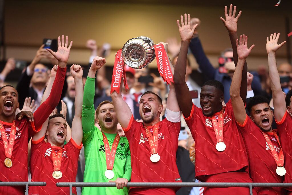 LONDON, ENGLAND - MAY 14: Jordan Henderson of Liverpool lifts The Emirates FA Cup trophy after their sides victory during The FA Cup Final match between Chelsea and Liverpool at Wembley Stadium on May 14, 2022 in London, England. (Photo by Michael Regan - The FA/The FA via Getty Images)