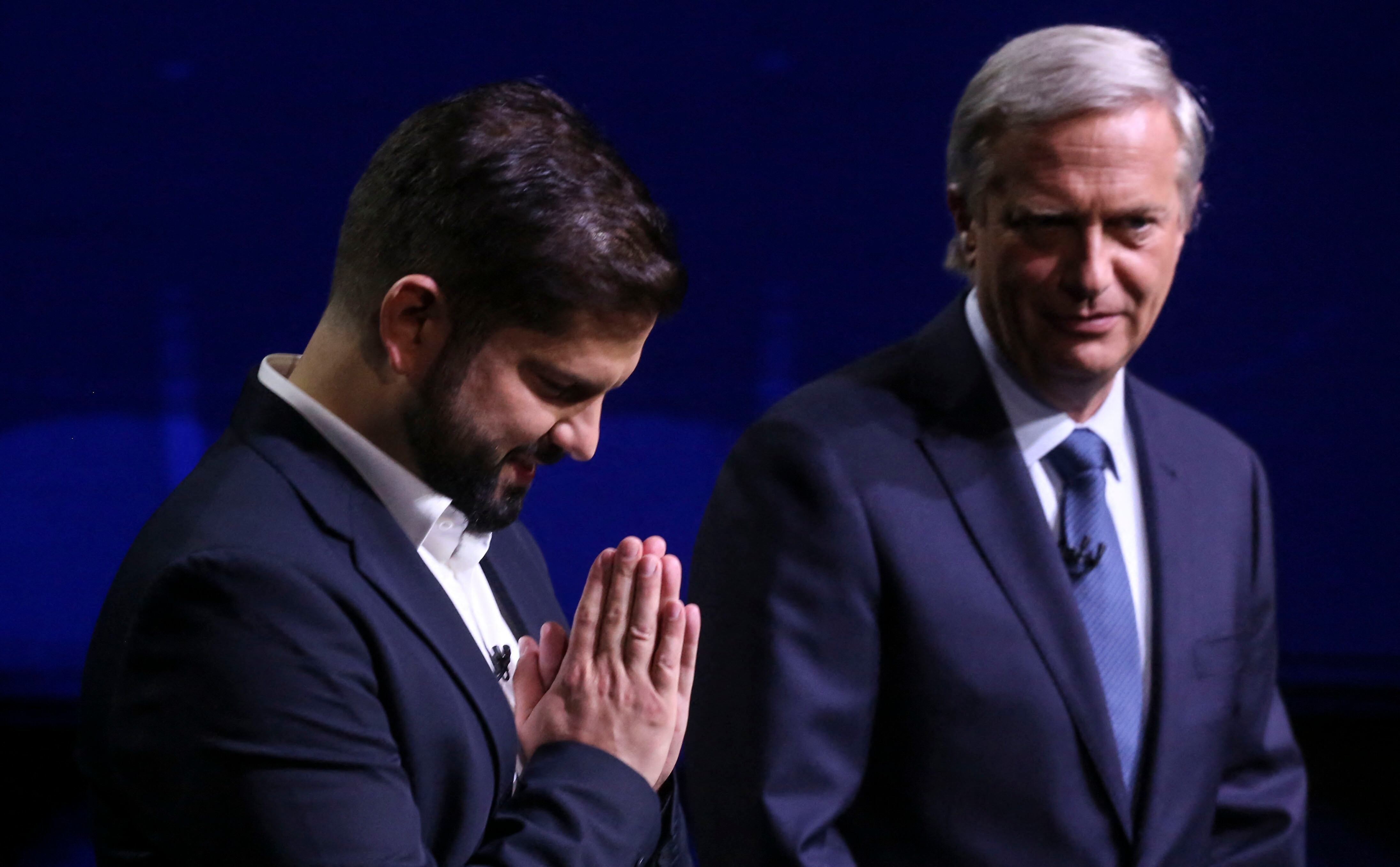 Chilean presidential candidate Gabriel Boric (L), from the Apruebo Dignidad party, and Chilean presidential candidate Jose Antonio Kast,  from the Partido Republicano party  poses before a debate in Santiago, on December 13, 2021, ahead of the presidential run-off election. (Photo by ELVIS GONZALEZ / POOL / AFP) (Photo by ELVIS GONZALEZ/POOL/AFP via Getty Images)