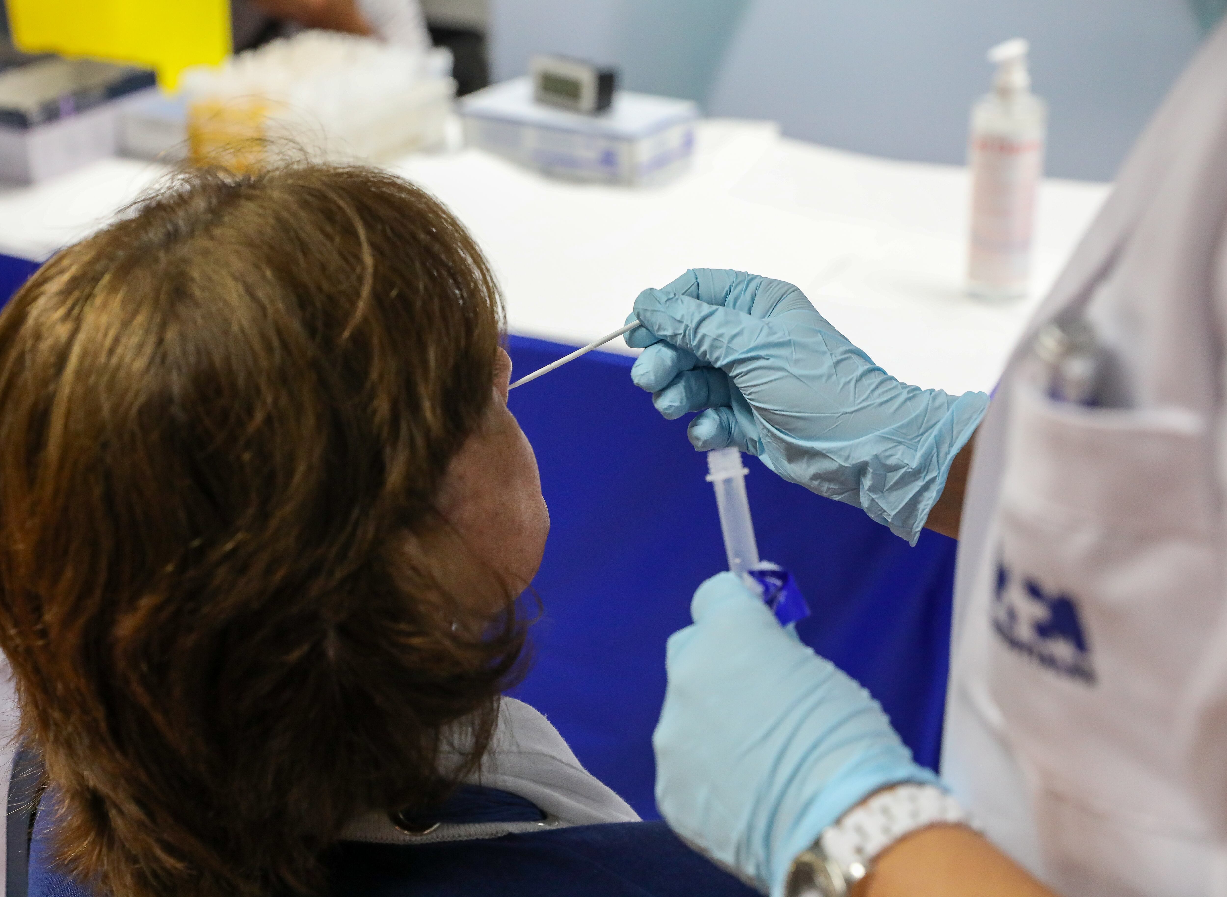 MADRID, SPAIN - JUNE 24: A health worker performs an antigen test on a woman at the Plaza de Castilla interchange, on 24 June 2021, in Madrid, (Spain). More than 2,500 people have already signed up for a free antigen test starting this Thursday at the Plaza Castilla interchange, according to the president of the Community. Through the Plan Sumamos, the Ministry of Health makes the antigen tests available to the HM Hospitals Group, the CEOE Foundation and the Confederation of Employers of Madrid (CEIM), which offer free of charge teams of health professionals to perform the tests at the interchange. (Photo By Marta Fernandez Jara/Europa Press via Getty Images)