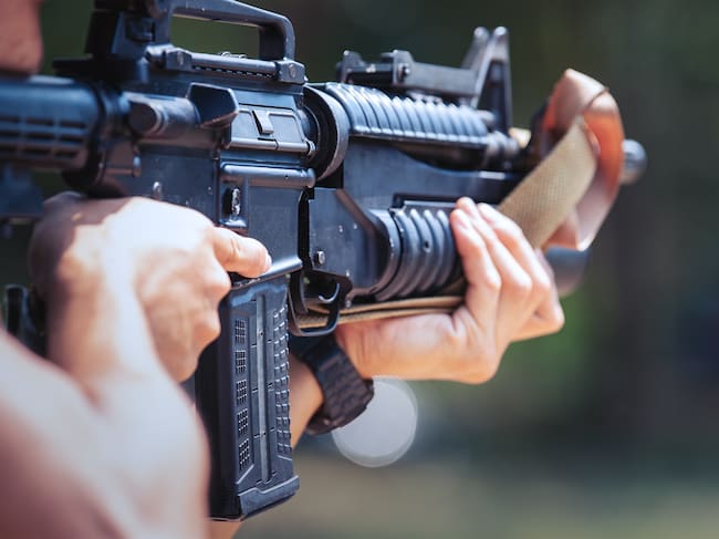 Unrecognizable soldier holding machine gun