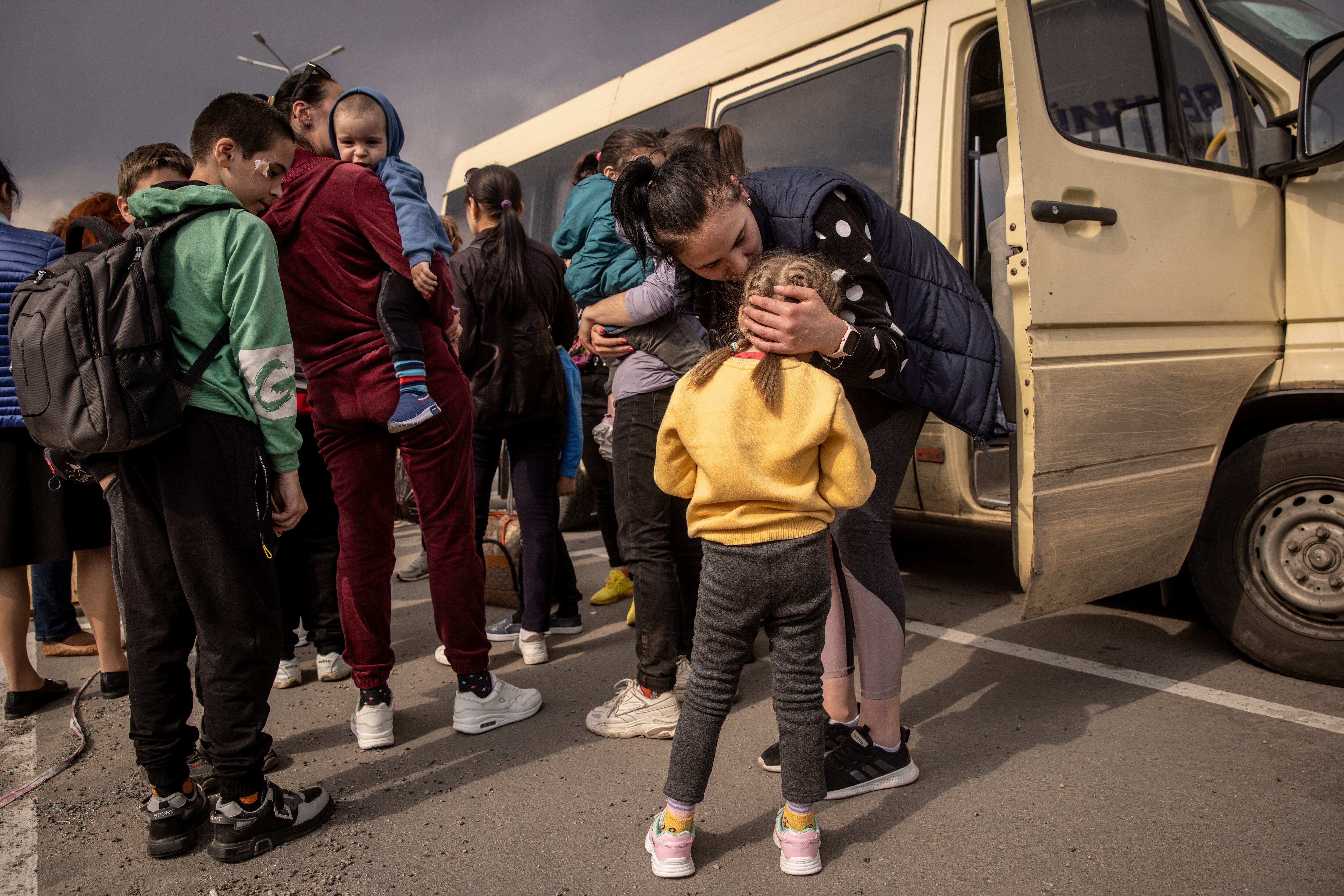 ZAPORIZHZHIA, UKRAINE - MAY 02: A woman kisses a girl after  arriving at an evacuation point for people fleeing Mariupol, Melitopol and the surrounding towns under Russian control on May 02, 2022 in Zaporizhzhia, Ukraine.Dozens of refugees were expected to arrive here from Mariupol, including the Azovstal steel facility, following extensive negotiations between representatives of Ukraine, Russia, the United Nations and the International Committee of the Red Cross. (Photo by Chris McGrath/Getty Images)