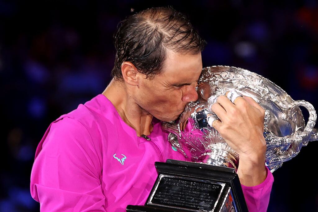 MELBOURNE, AUSTRALIA - JANUARY 30: Rafael Nadal of Spain kisses the Norman Brookes Challenge Cup as he celebrates victory in his Men’s Singles Final match against Daniil Medvedev of Russia during day 14 of the 2022 Australian Open at Melbourne Park on January 30, 2022 in Melbourne, Australia. (Photo by Clive Brunskill/Getty Images)