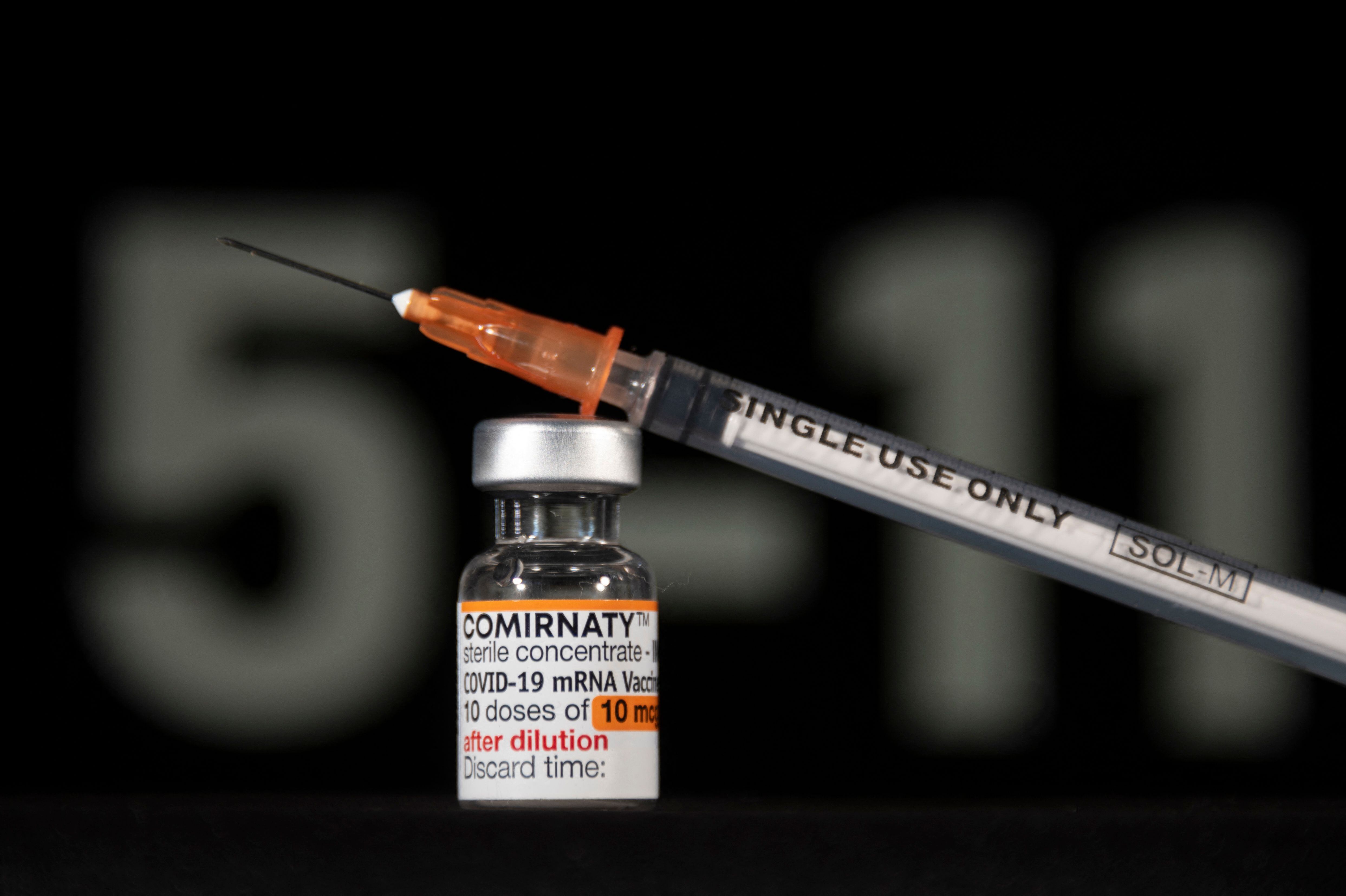 A vial of Pfizer/BioNTech Covid-19 vaccine for children and labelled with an orange coloured band, is pictured with a syringe in Mulhouse, eastern France, on December 23, 2021. (Photo by SEBASTIEN BOZON / AFP) (Photo by SEBASTIEN BOZON/AFP via Getty Images)