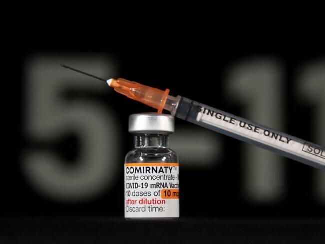 A vial of Pfizer/BioNTech Covid-19 vaccine for children and labelled with an orange coloured band, is pictured with a syringe in Mulhouse, eastern France, on December 23, 2021. (Photo by SEBASTIEN BOZON / AFP) (Photo by SEBASTIEN BOZON/AFP via Getty Images)