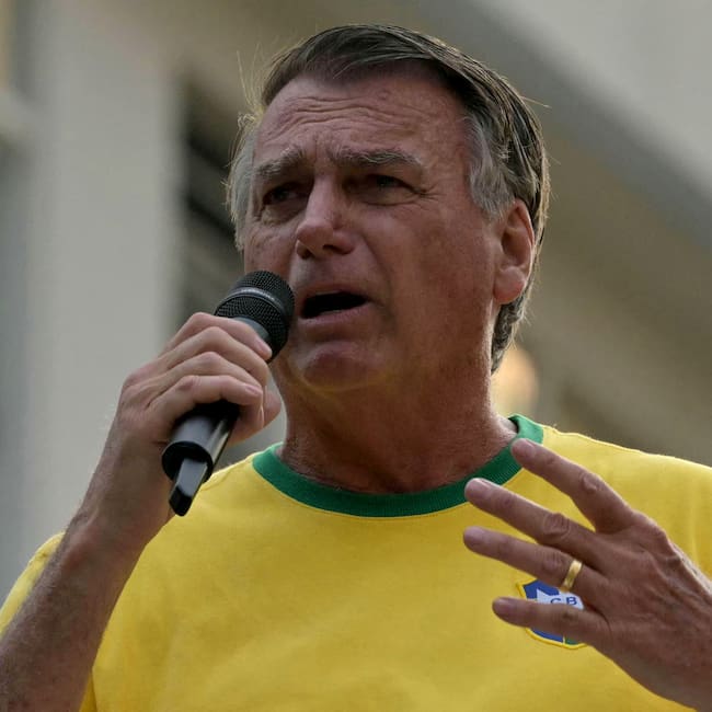 (FILES) Brazil's former President (2019-2023) Jair Bolsonaro speaks to supporters during an Independence day rally in Sao Paulo, Brazil on September 7, 2024. Bolsonaro, sentenced last September to 27 years in prison for a failed coup attempt but not yet serving his term, was taken into police custody on November 22 after trying to burn the ankle monitor tracking his house arrest, though he later claimed he acted out of �paranoia� when attempting to disable the device. (Photo by NELSON ALMEIDA / AFP)