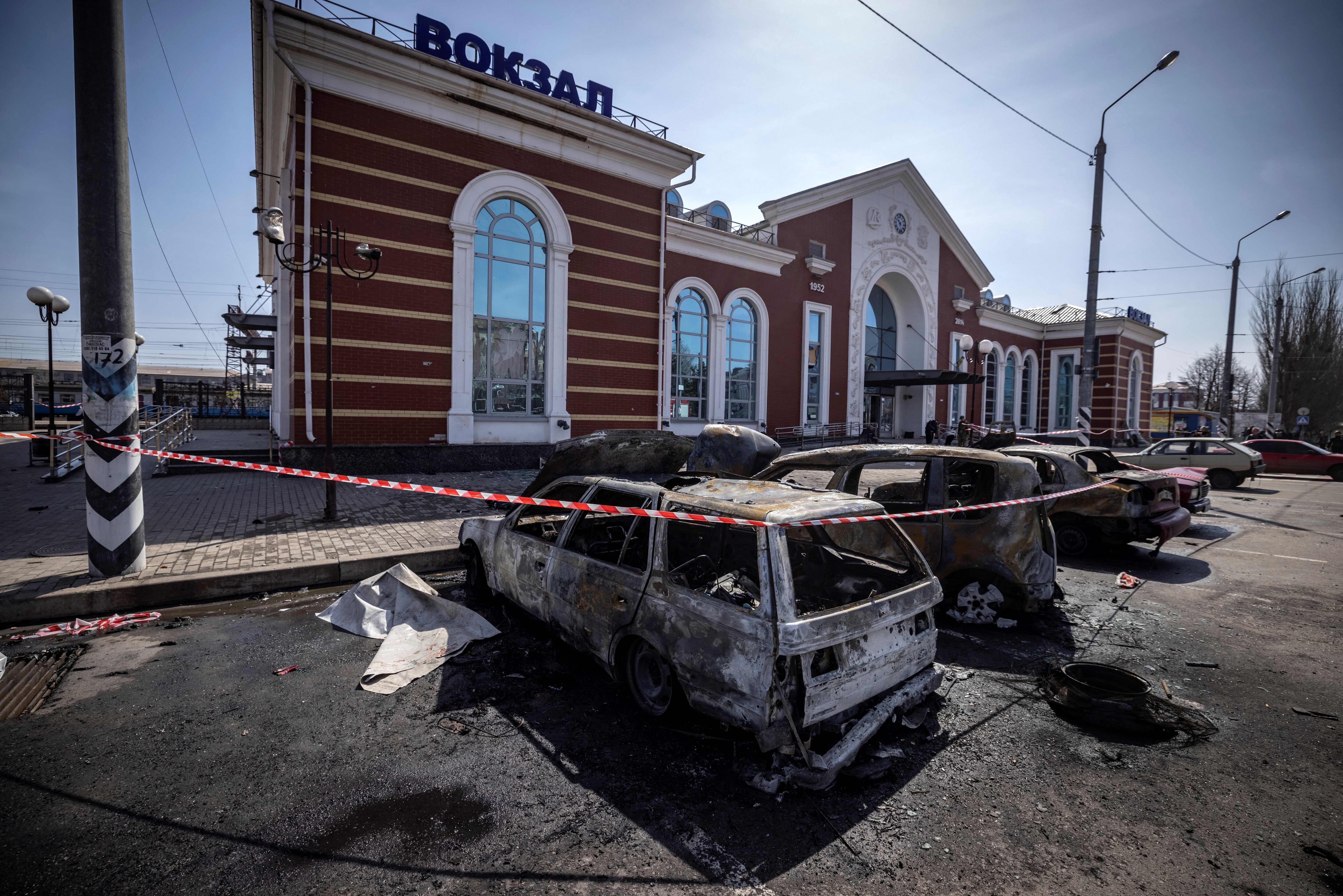 Calcinated cars are pictured outside a train station in Kramatorsk, eastern Ukraine, that was being used for civilian evacuations, after it was hit by a rocket attack killing at least 35 people, on April 8, 2022. (Photo by FADEL SENNA / AFP) (Photo by FADEL SENNA/AFP via Getty Images)