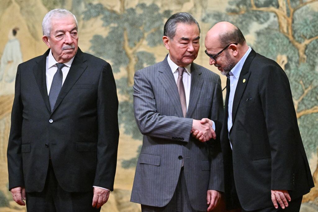 Mahmoud al-Aloul, Wang Yi y Mussa Abu Marzuk. I Foto: PEDRO PARDO/POOL/AFP via Getty Images)