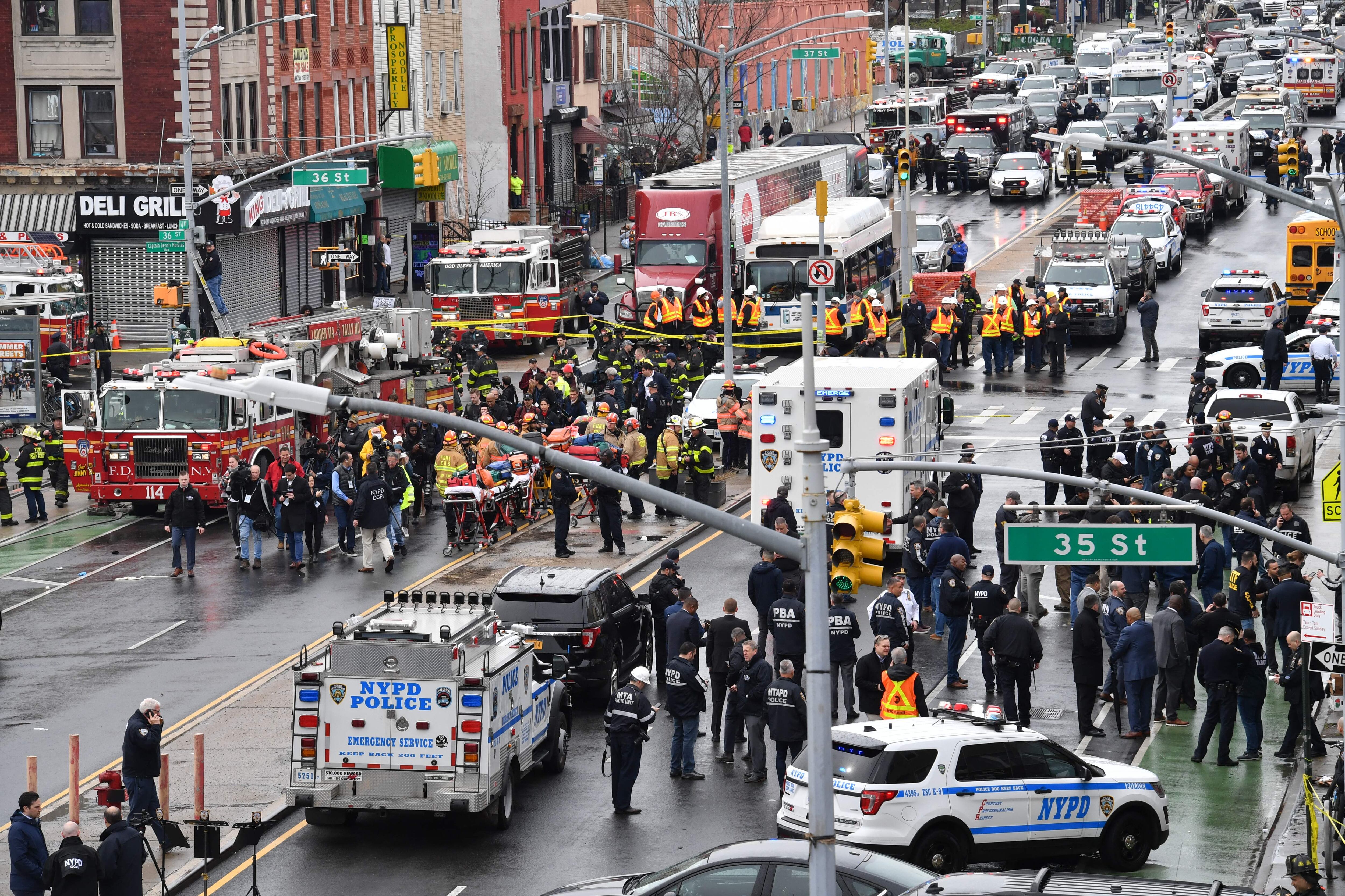 Members of the New York Police Department and emergency vehicles crowd the streets after at least 13 people were injured during a rush-hour shooting at a subway station in the New York borough of Brooklyn on April 12, 2022. (Photo by ANGELA  WEISS / AFP) (Photo by ANGELA  WEISS/AFP via Getty Images)
