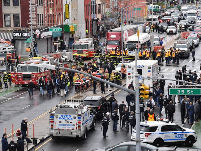 Members of the New York Police Department and emergency vehicles crowd the streets after at least 13 people were injured during a rush-hour shooting at a subway station in the New York borough of Brooklyn on April 12, 2022. (Photo by ANGELA  WEISS / AFP) (Photo by ANGELA  WEISS/AFP via Getty Images)