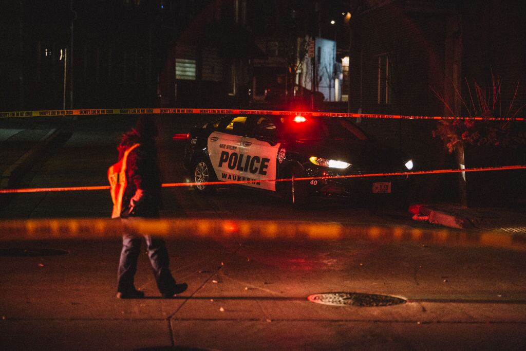WAUKESHA, WI - NOVEMBER 21: Police and emergency personnel work on a crime scene on November 21, 2021 in Waukesha, Wisconsin. According to reports, an SUV drove through pedestrians at a holiday parade, killing at least one and injuring 20 more. (Photo by Jim Vondruska/Getty Images)