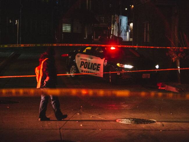 WAUKESHA, WI - NOVEMBER 21: Police and emergency personnel work on a crime scene on November 21, 2021 in Waukesha, Wisconsin. According to reports, an SUV drove through pedestrians at a holiday parade, killing at least one and injuring 20 more. (Photo by Jim Vondruska/Getty Images)