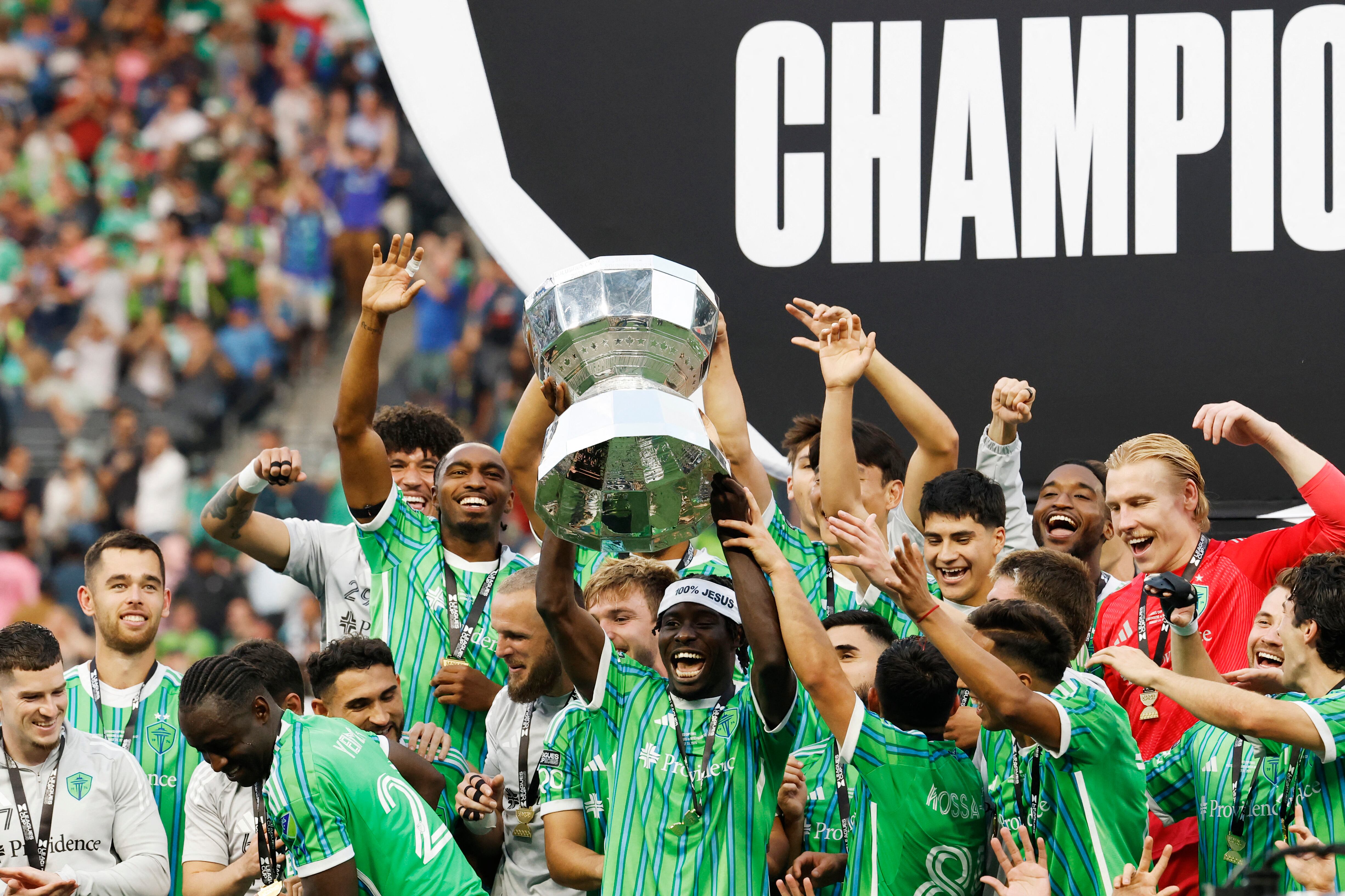 SEATTLE, WASHINGTON - AUGUST 31: Georgi Minoungou #93 of the Seattle Sounders FC lifts the Champion's trophy after winning the Leagues Cup Final match between Seattle Sounders and Inter Miami CF at Lumen Field on August 31, 2025 in Seattle, Washington.   Alika Jenner/Getty Images/AFP (Photo by Alika Jenner / GETTY IMAGES NORTH AMERICA / Getty Images via AFP)