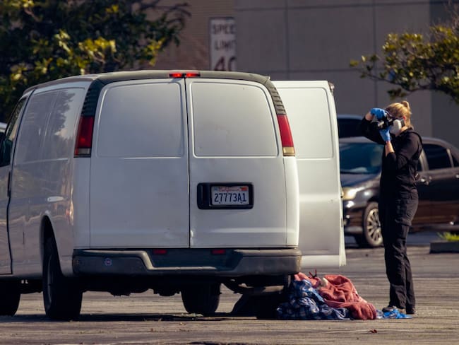 TORRANCE PARK, CA - JANUARY 22: An investigator photographs a van at the scene of a S.W.A.T. operation on January 22, 2023 in Torrance, California. Armored vehicles were used to entrap a vehicle driven by a suspect in a mass shooting in Monterey Park, east of Los Angeles. 10 people were killed and 10 more were injured at a dance studio in Monterey Park near a Lunar New Year celebration last night.  (Photo by David McNew/Getty Images)