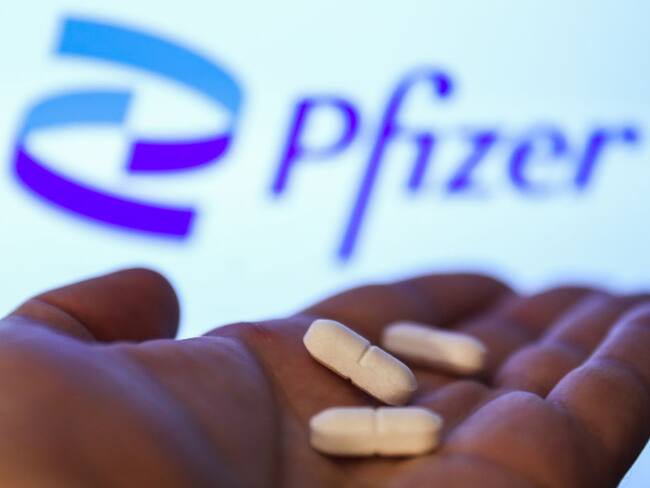 Medicine pills are seen with Pfizer logo displayed on a screen in the background in this illustration photo taken in Krakow, Poland on April 27, 2021. (Photo Illustration by Jakub Porzycki/NurPhoto via Getty Images)