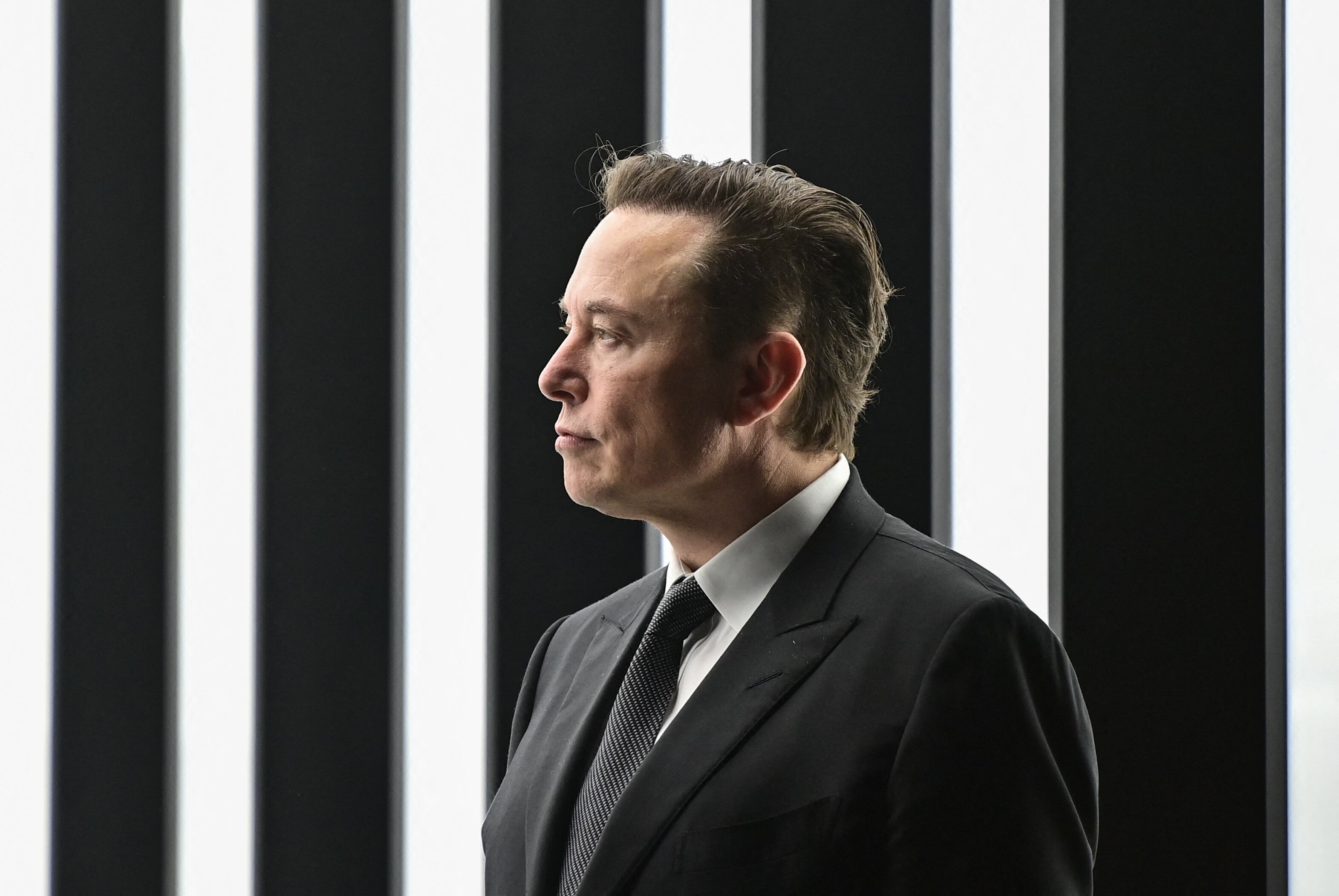 Tesla CEO Elon Musk is pictured as he attends the start of the production at Tesla's "Gigafactory" on March 22, 2022 in Gruenheide, southeast of Berlin. - US electric car pioneer Tesla received the go-ahead for its "gigafactory" in Germany on March 4, 2022, paving the way for production to begin shortly after an approval process dogged by delays and setbacks. (Photo by Patrick Pleul / POOL / AFP) (Photo by PATRICK PLEUL/POOL/AFP via Getty Images)