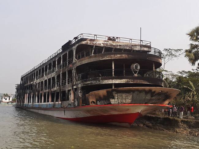 The burnt-out ferry is seen anchored along a coast a day after it caught fire killing at least 37 people in Jhalkathi, 250 km (160 miles) south of Dhaka on December 24, 2021. (Photo by arifur rahman / AFP) (Photo by ARIFUR RAHMAN/AFP via Getty Images)
