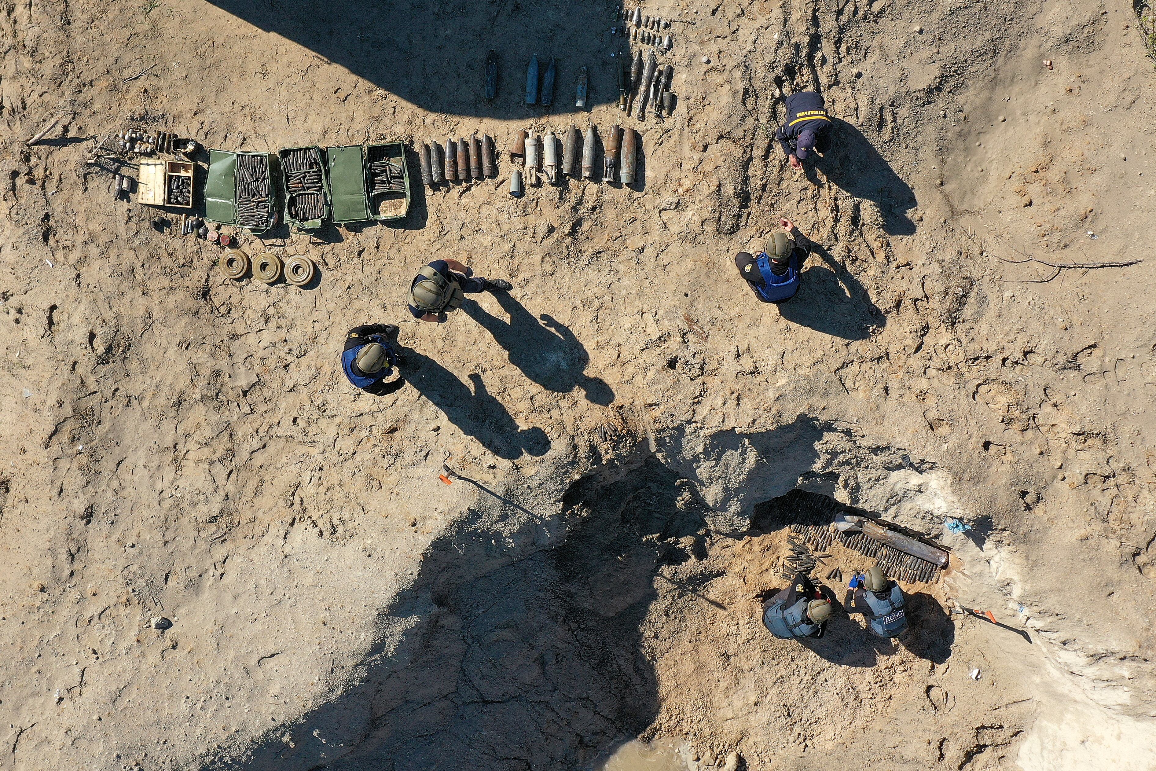 BORODIANKA, UKRAINE - JUNE 3: Bomb disposal experts from the Ukrainian State Emergency Service prepare for a controlled explosion of 1 ton of unexploded missiles, artillery shells and mines that they have retrieved during the last week in the Borodianka area on June 03, 2022 in Borodianka, Ukraine. The demining and clearing of unexploded ordnance in Ukraine after the Russian invasion could take between 5-7 years, in the Kyiv region alone they have already removed over 36,000 items of dangerous ordnance. (Photo by Christopher Furlong/Getty Images)
